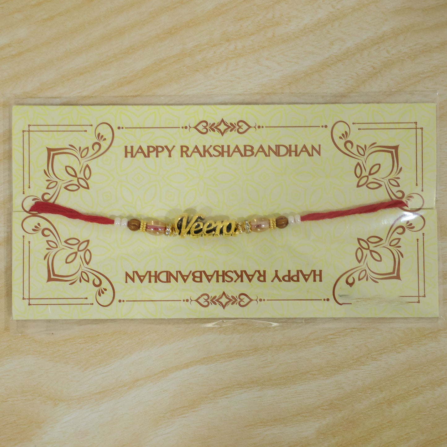 Veera Name Golden Rakhi with White Brown Beads, Red Thread and Premium Finish