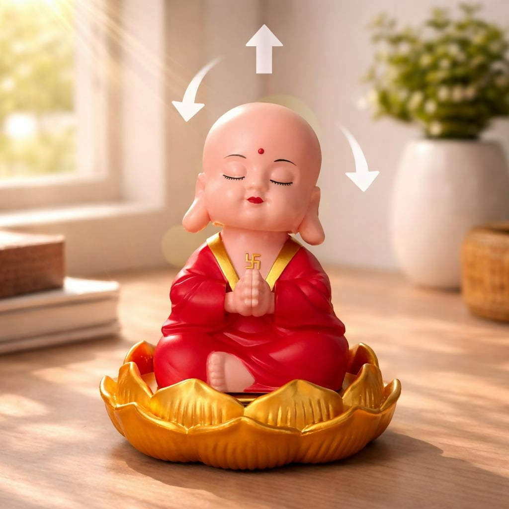 Car dashboard with solar monk bobble head