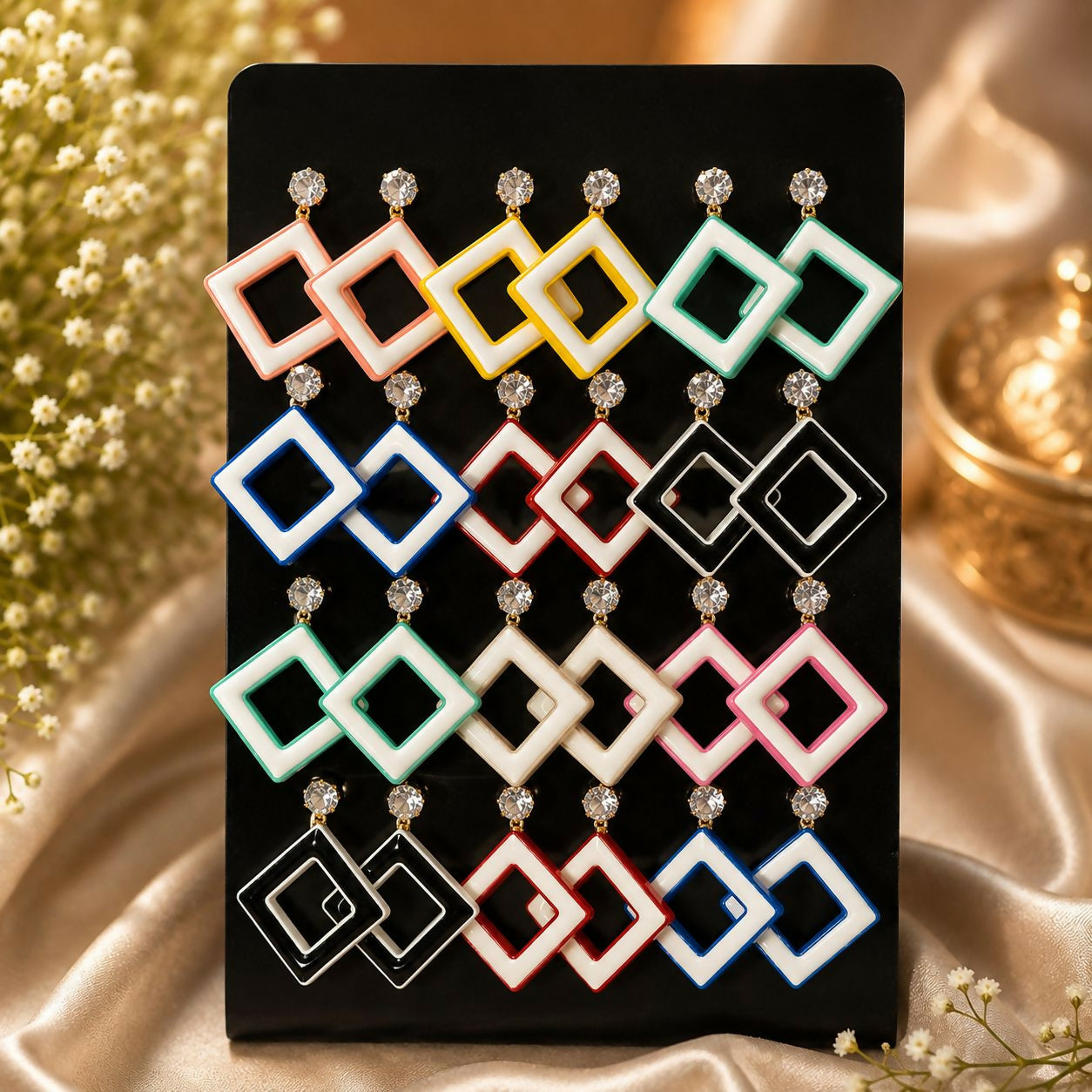 Colorful geometric drop earrings set with sparkling crystal studs.