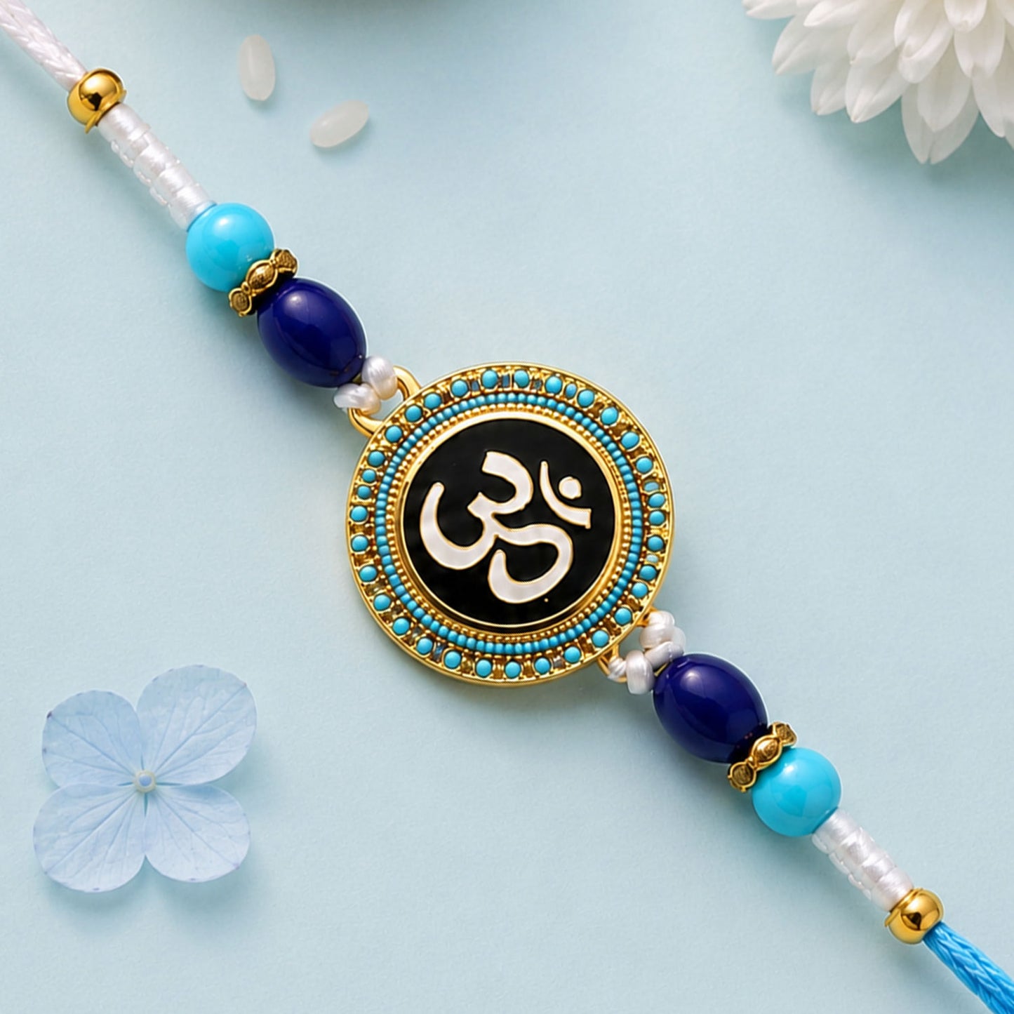 Round Om Stone Studded Enamel Rakhi with Cute Doll Keychain Combo (2 Pc)