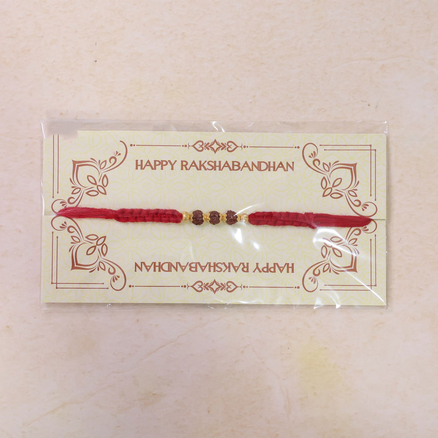 Red Braided Rakhi with Rudraksha Beads and Golden Bead Accents