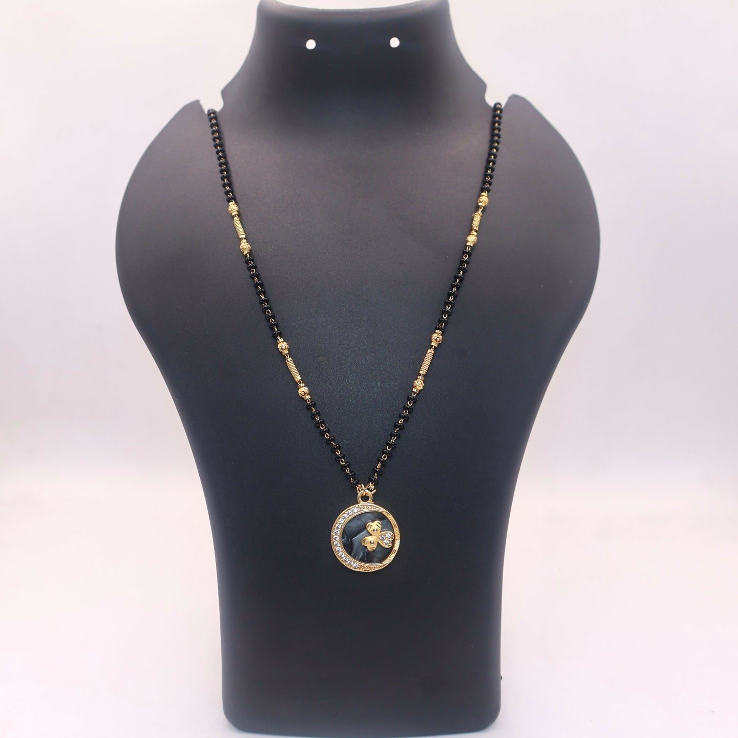 Black beads chain with gold spacers in butterfly coin pendant mangal sutra