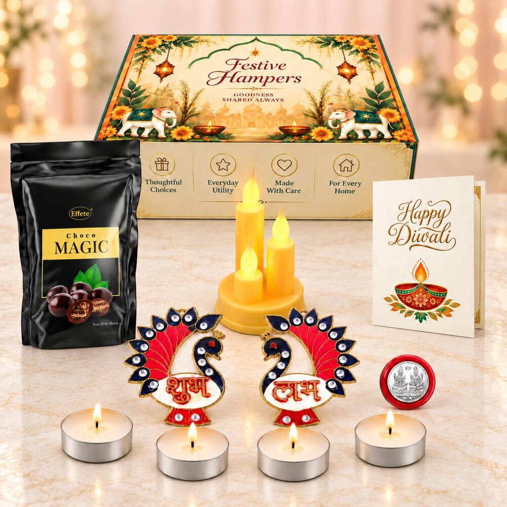A Diwali gift set with chocolate, LED candles, tealights, peacock decor, a silver coin, and a greeting card.