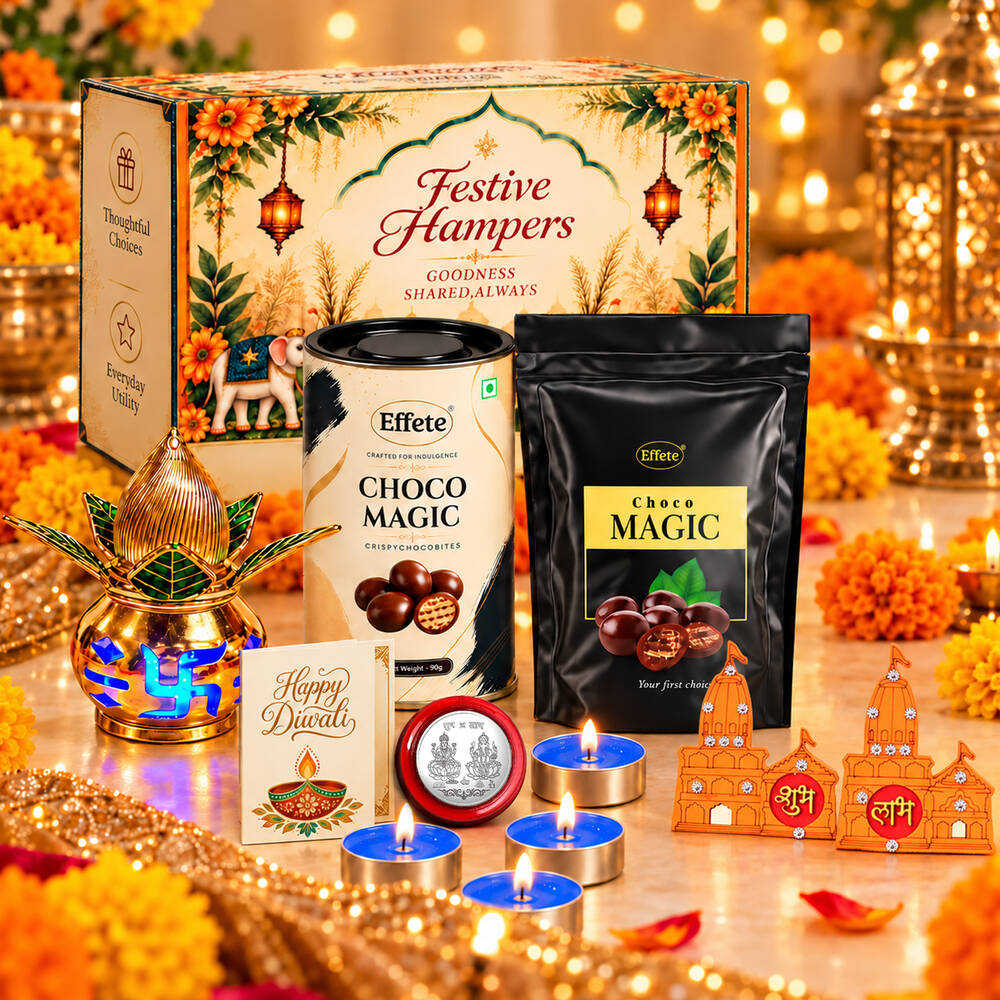 A Diwali gift set with a decorative box, two chocolate products, a golden kalash, tealights, and religious decor on a
