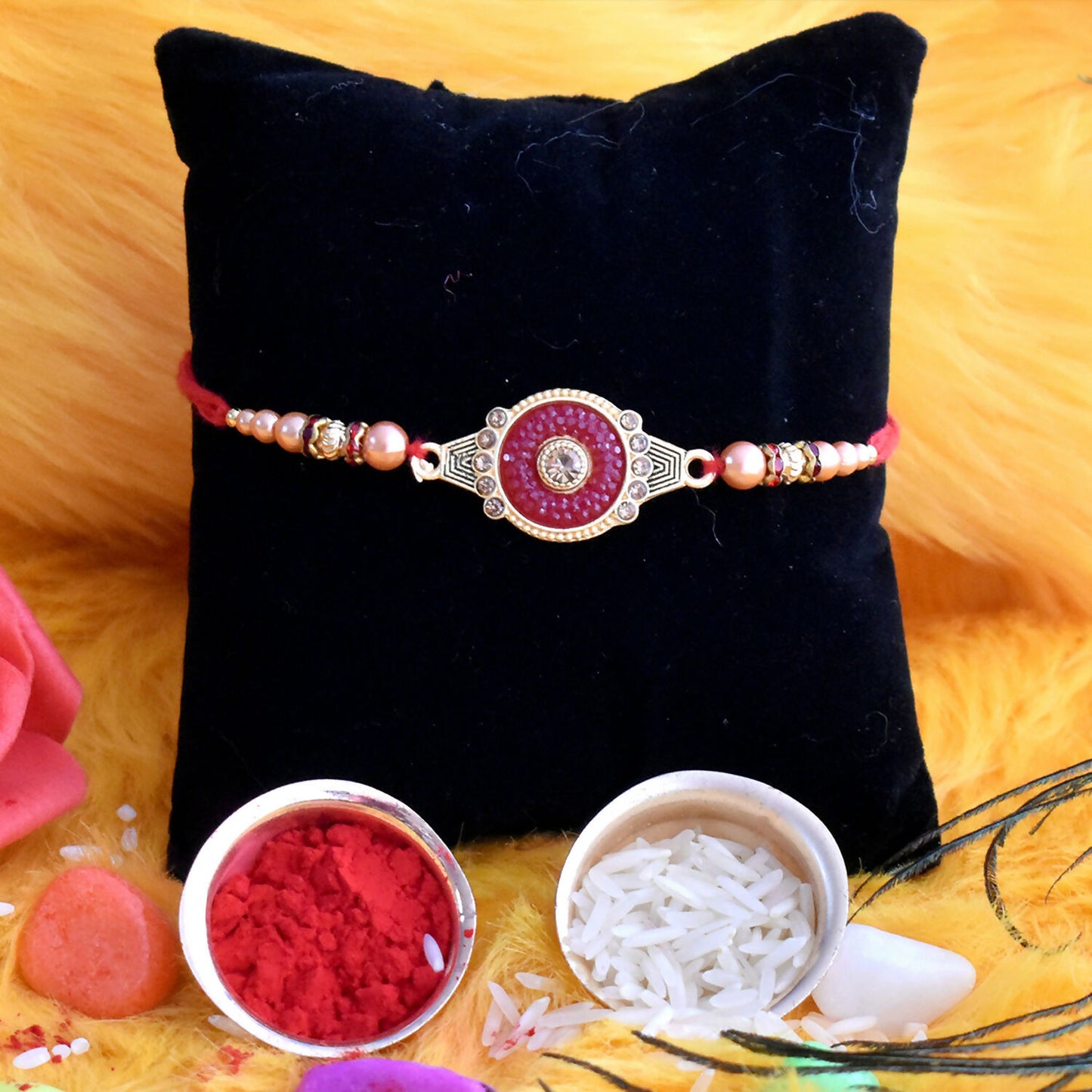 Traditional style red rakhi adorned with kundan stones and pearl beads