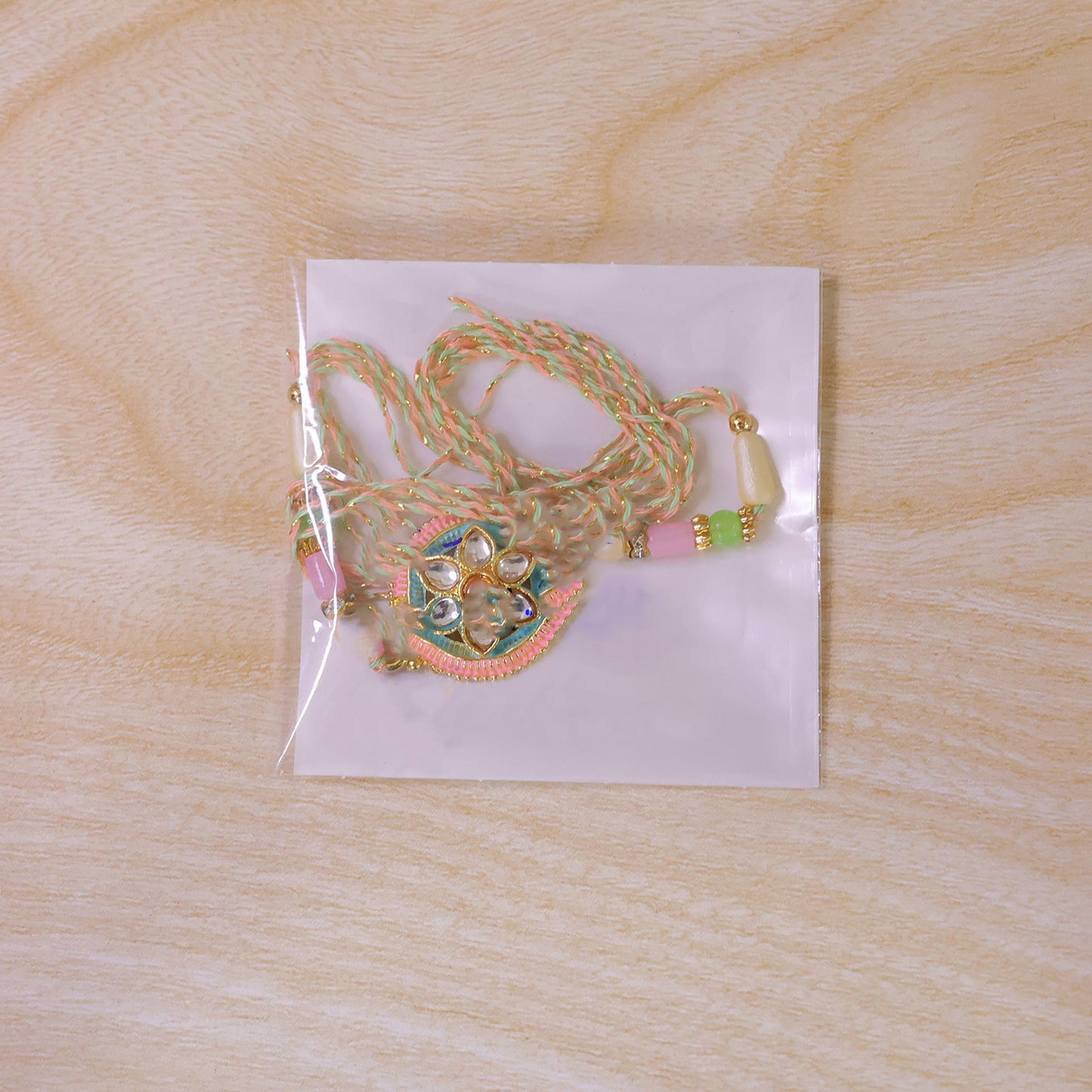 Teal and Pink Round Kundan Pendant Rakhi with Pastel Beads