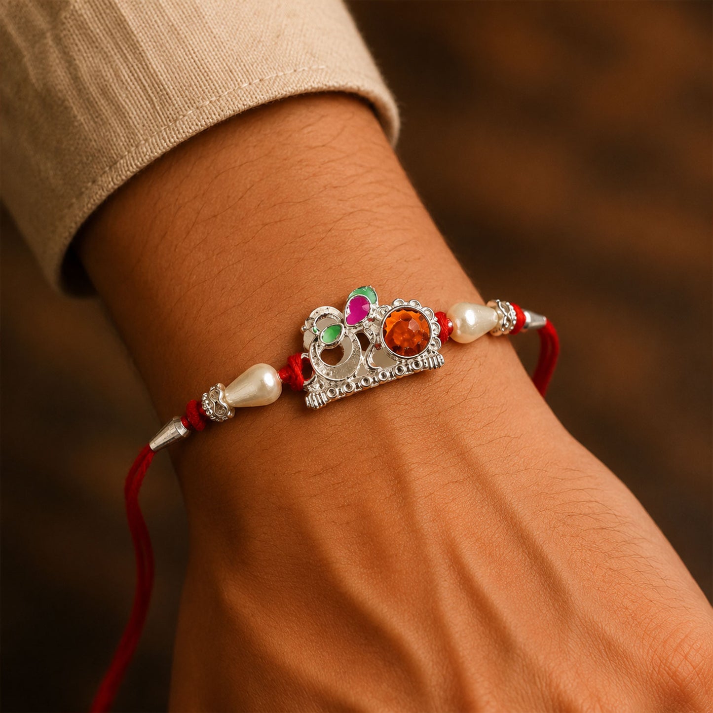 Red Gold Floral Om Rakhi with White Pearls and Orange Stone Center