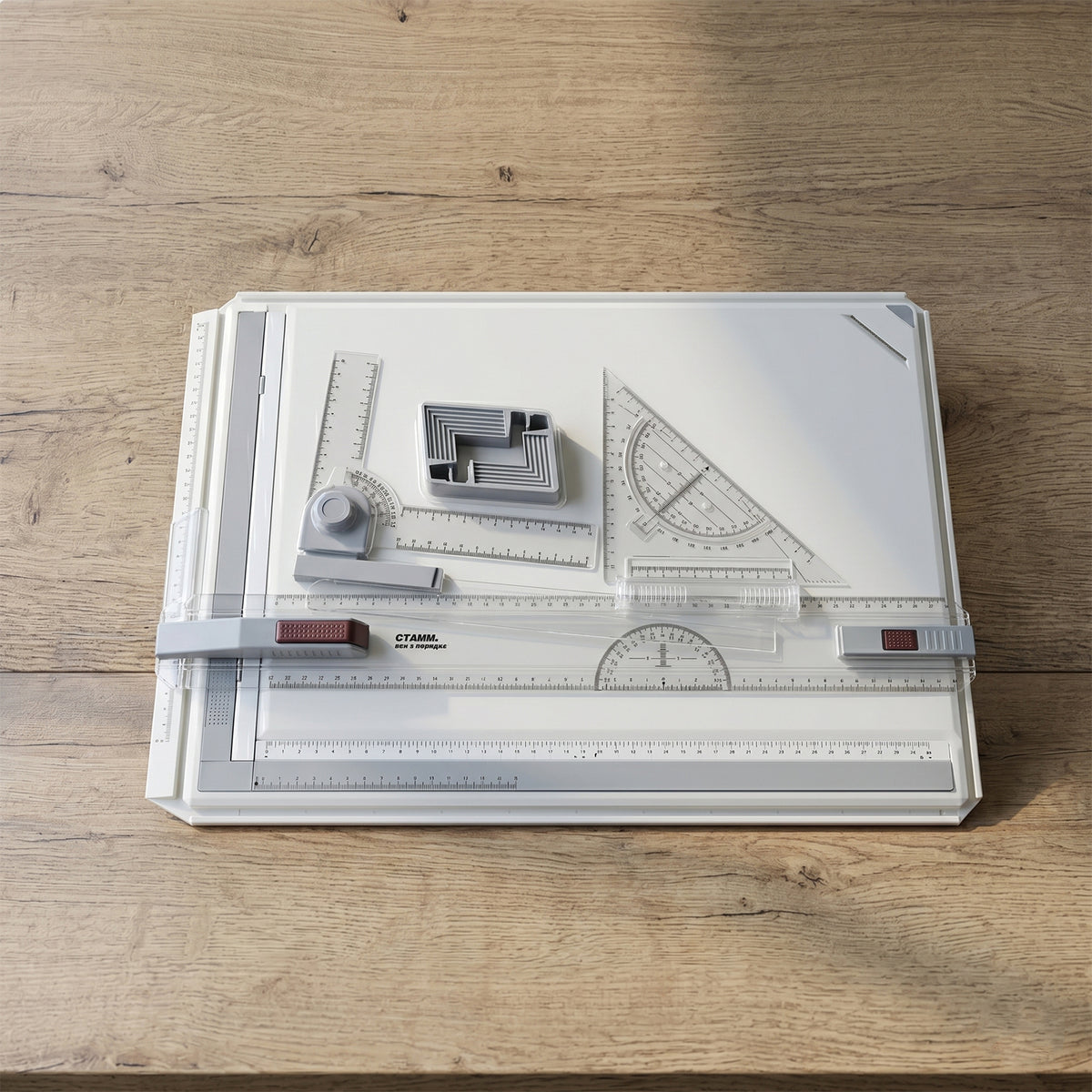 Close-up of sliding parallel ruler and set square on a drafting board.