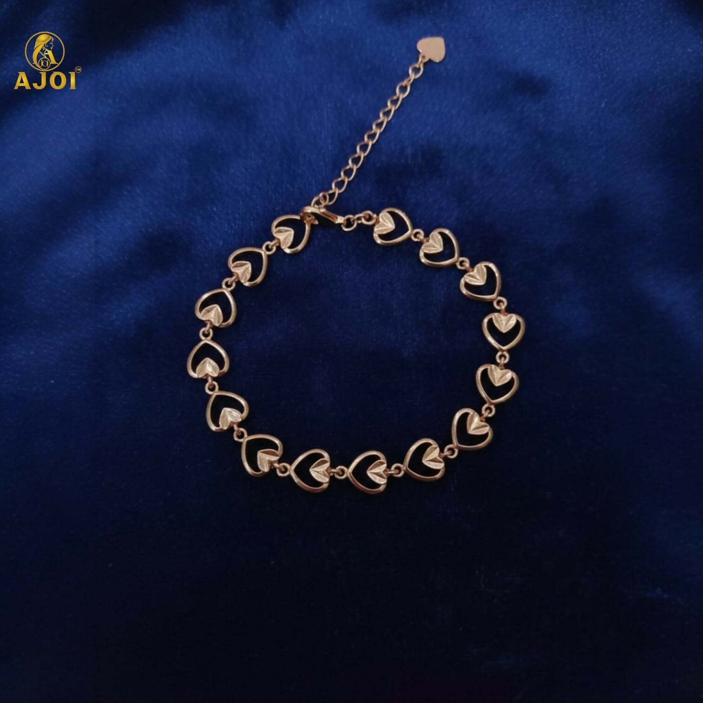 Elegant gold plated heart link bracelet shining under soft light