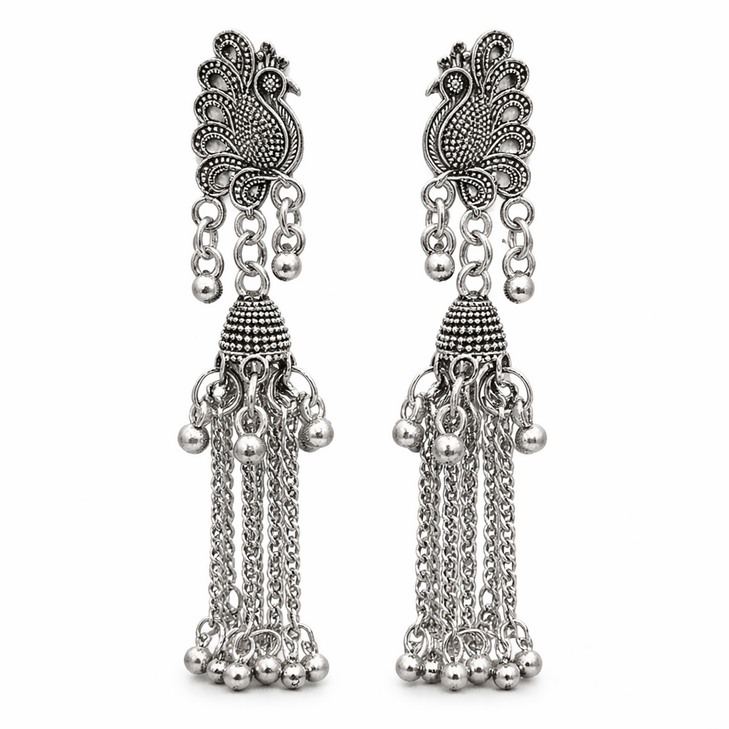 Side angle of oxidised peacock jhumka earrings with chain tassels