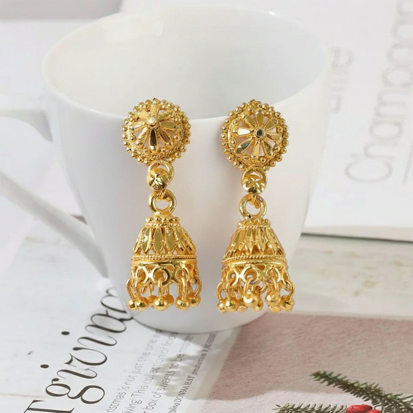 Gold plated floral jhumka earrings with intricate design and hanging beads