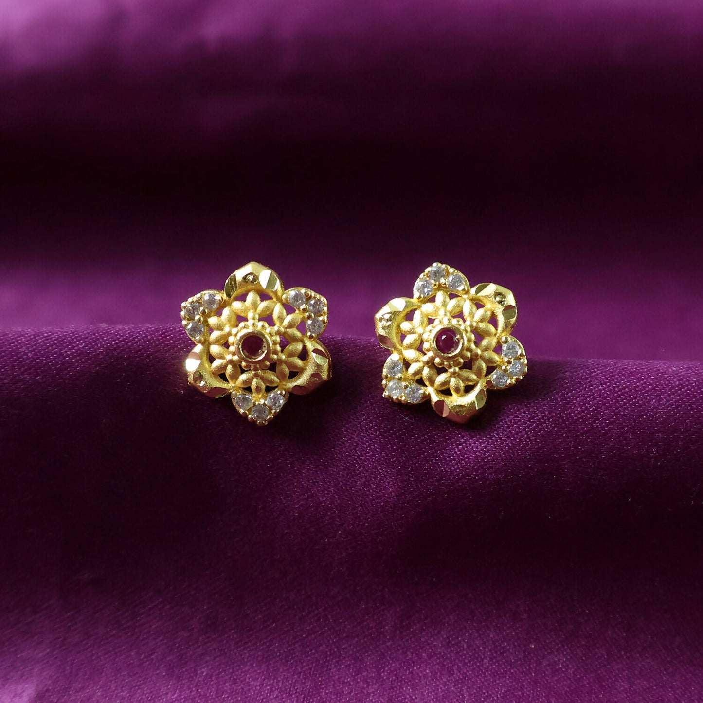 Beautifully crafted gold stud earrings with sparkling stone detail