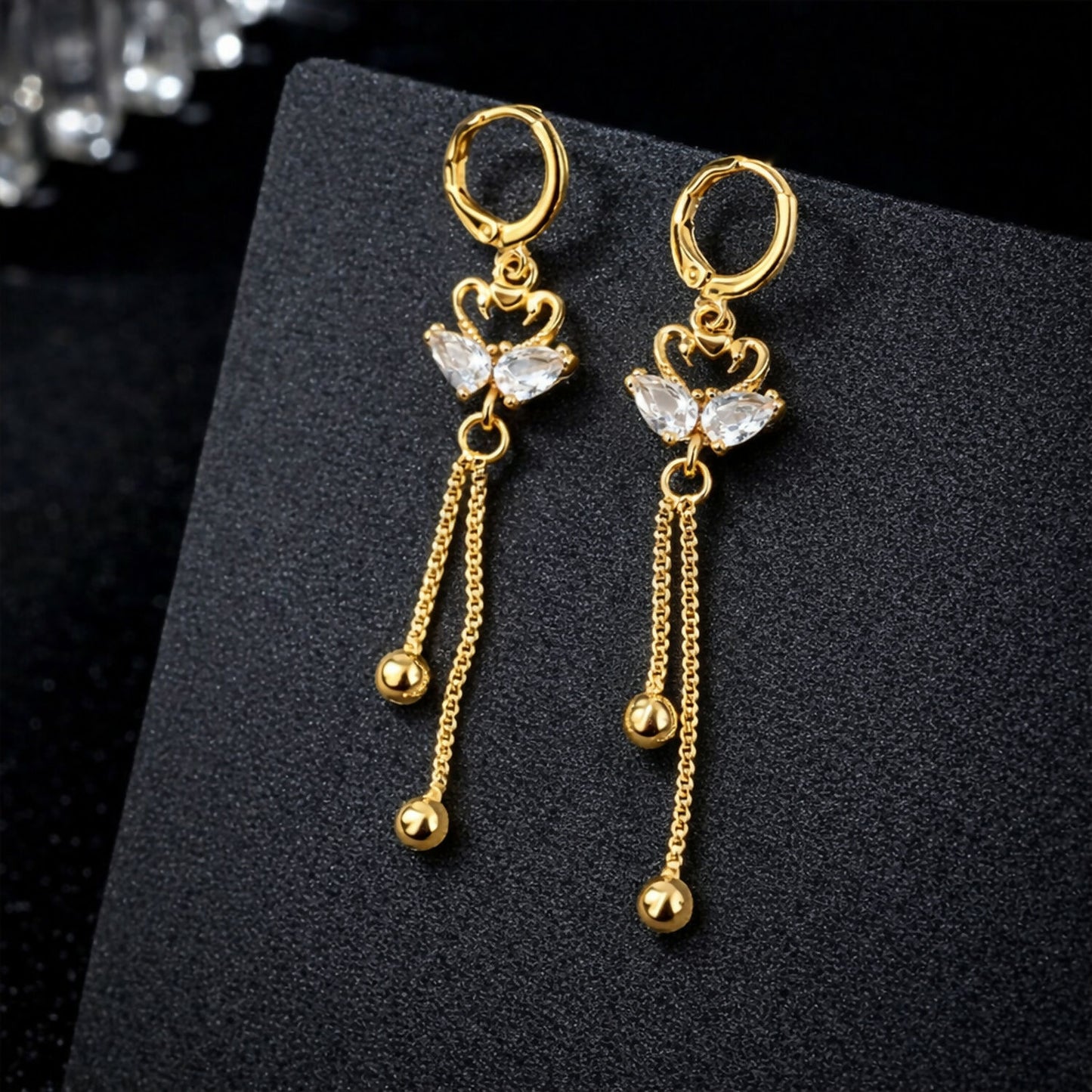 Golden swan dangle earrings with crystal heart and delicate chain drops