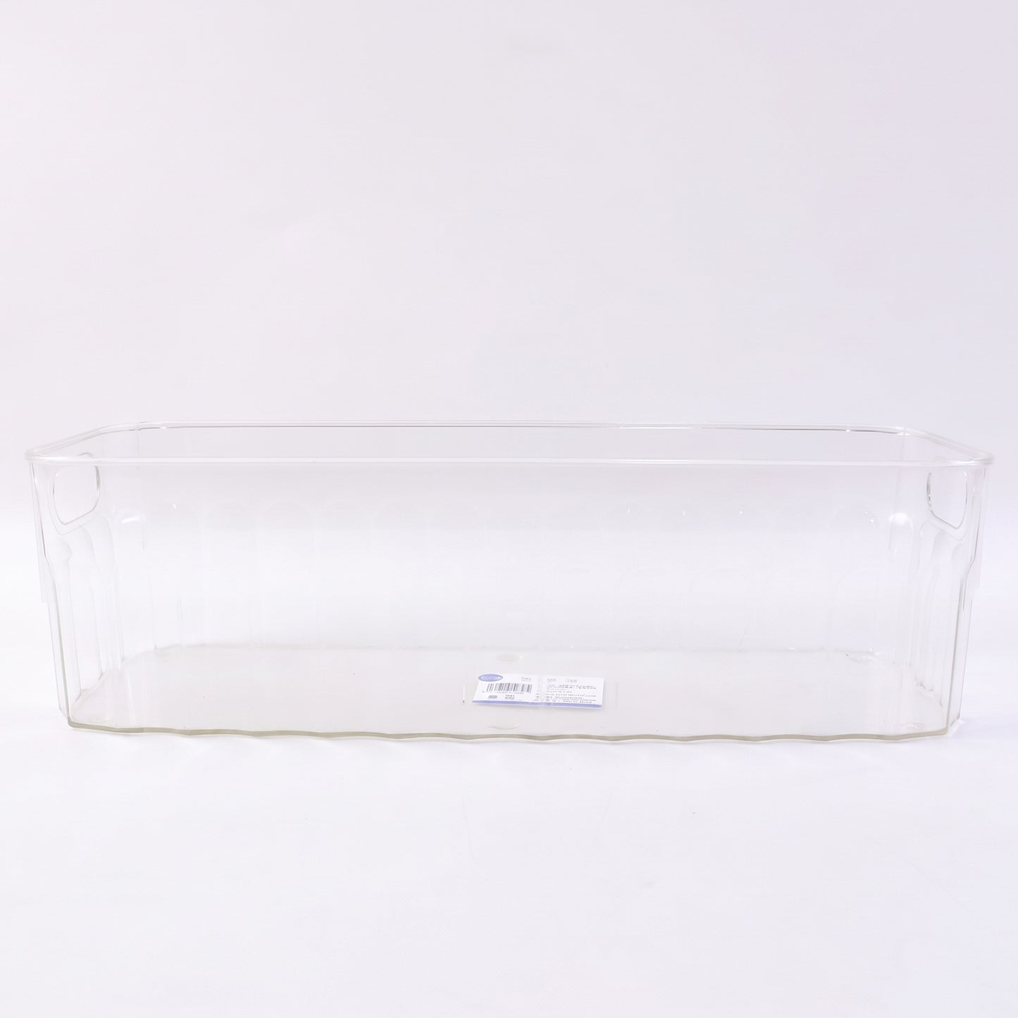 Decorative ribbed sides on a transparent storage basket for kitchen organization.