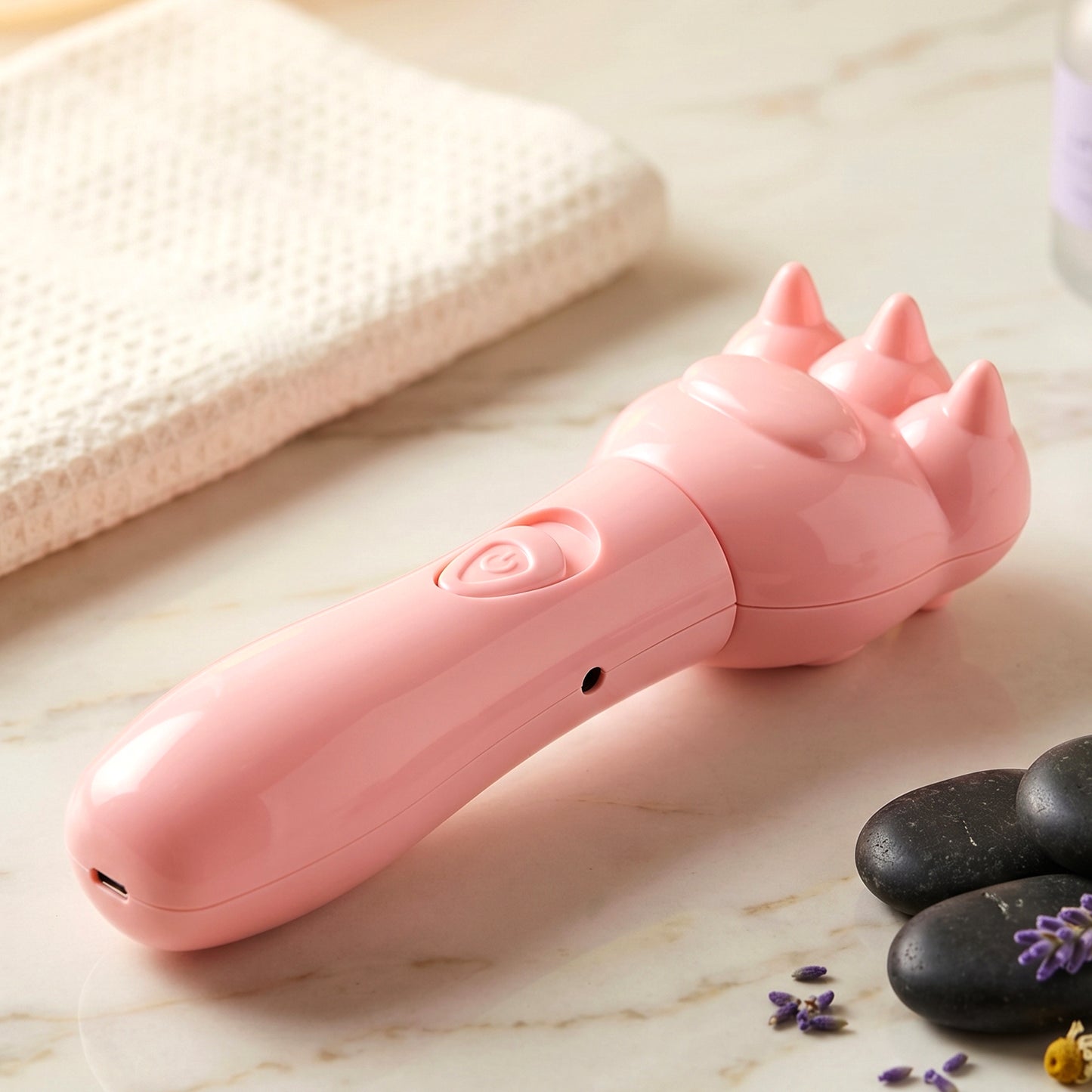 Close-up of bear shaped electric hand massager button
