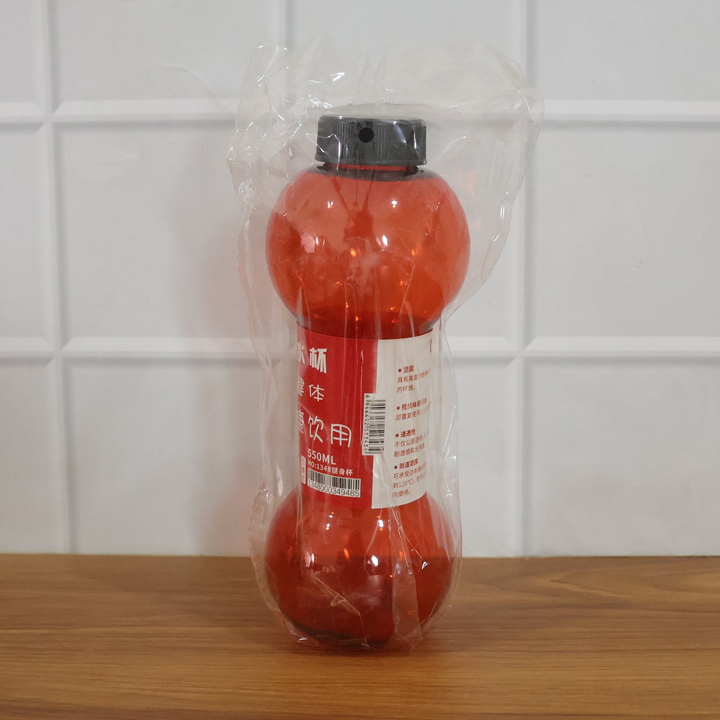 Stylish dumbbell water bottle angled view