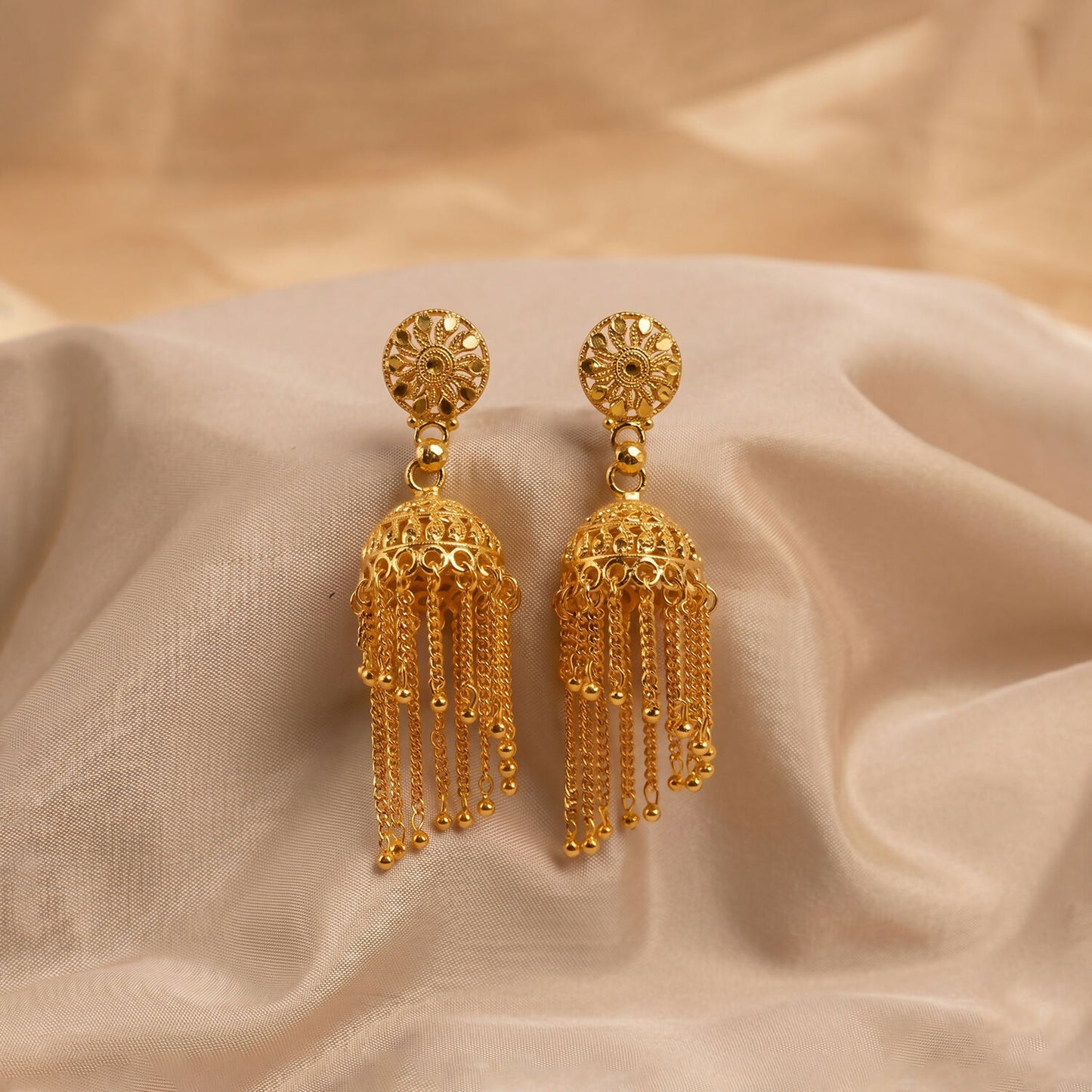 Golden Chain Tassel Jhumka Earrings on white background