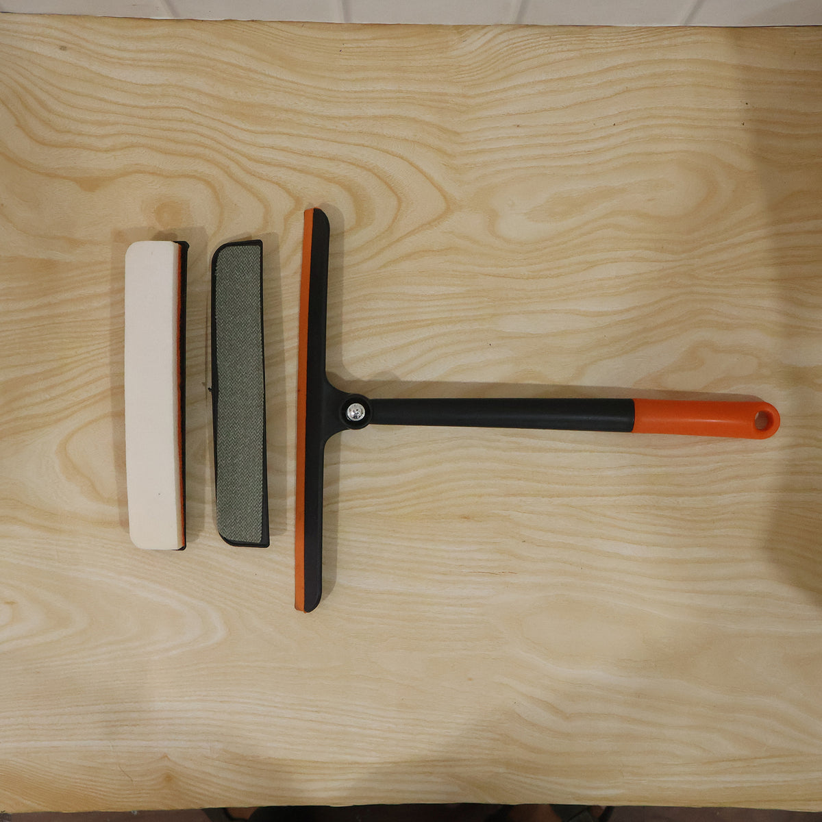 Complete view of glass cleaning squeegee in use on a window