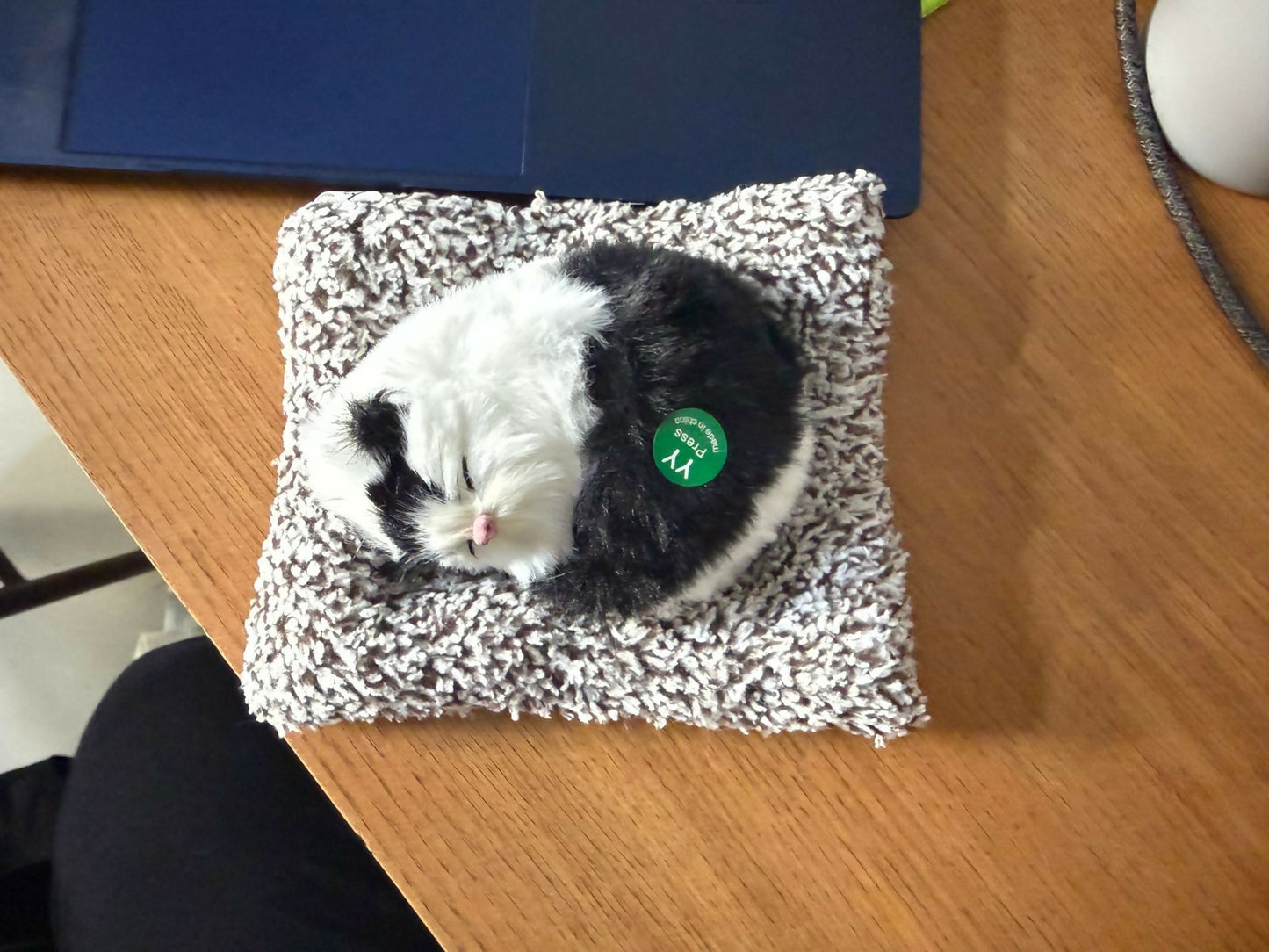 Sleeping cat plush toy resting on soft cushion decorative showpiece