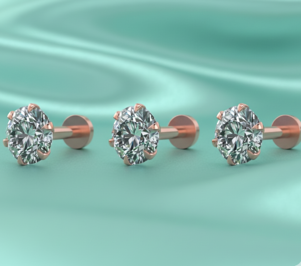 Close-up of rose gold plated solitaire stud earring with round-cut sparkling stone