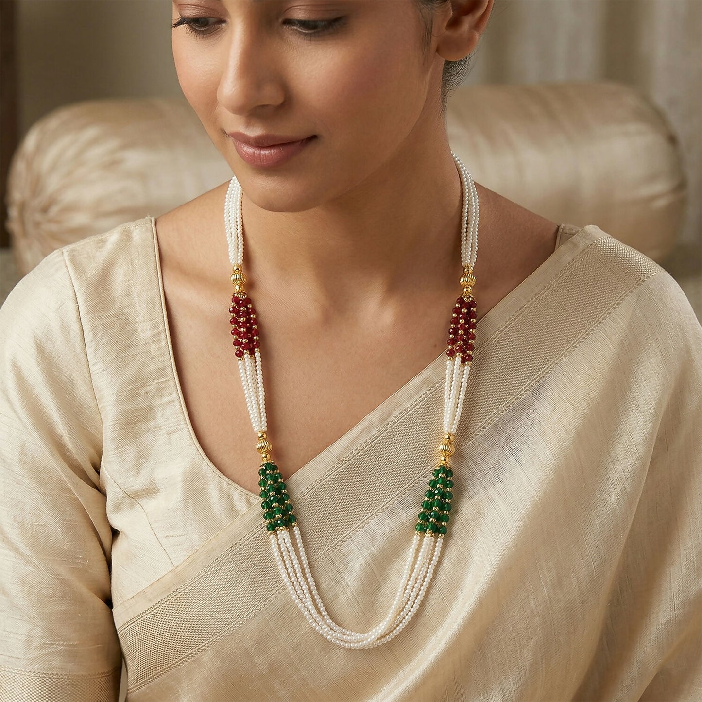 Close-up of beads and gold-toned details on traditional mala