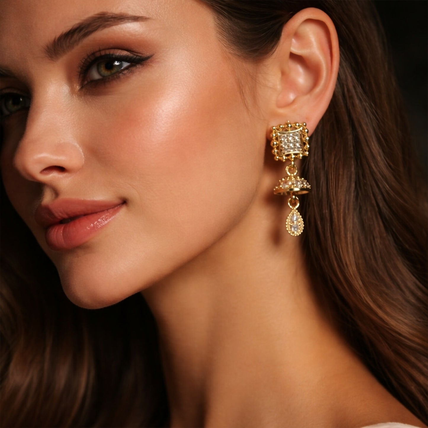 Close up of gold pavé crystal square studs on Jhumka-inspired earrings