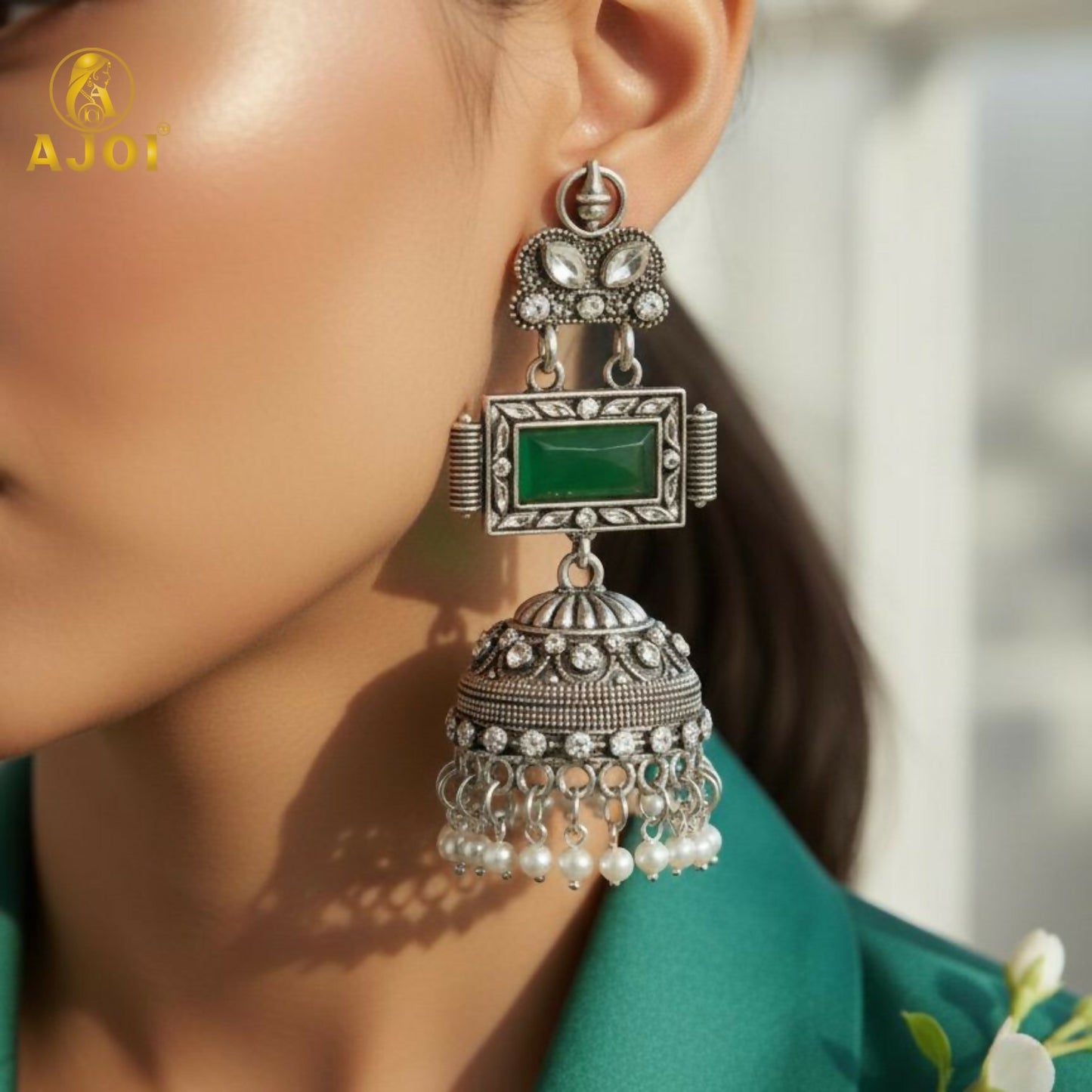 Imperial Heritage Oxidized Silver Jhumka Earrings with Deep Green Stone, Hand-Engraved Motifs, Crystal Accents & Pearl Drop Detailing.
