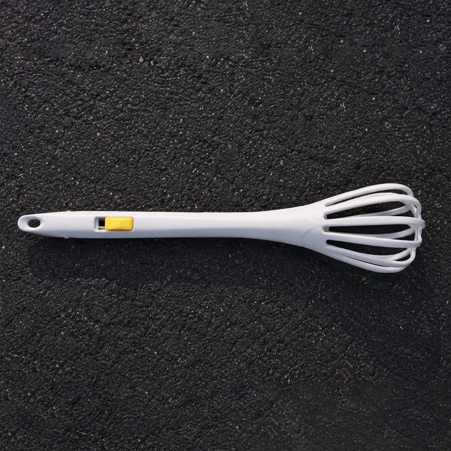 White manual egg beater with ergonomic handle for comfortable use.