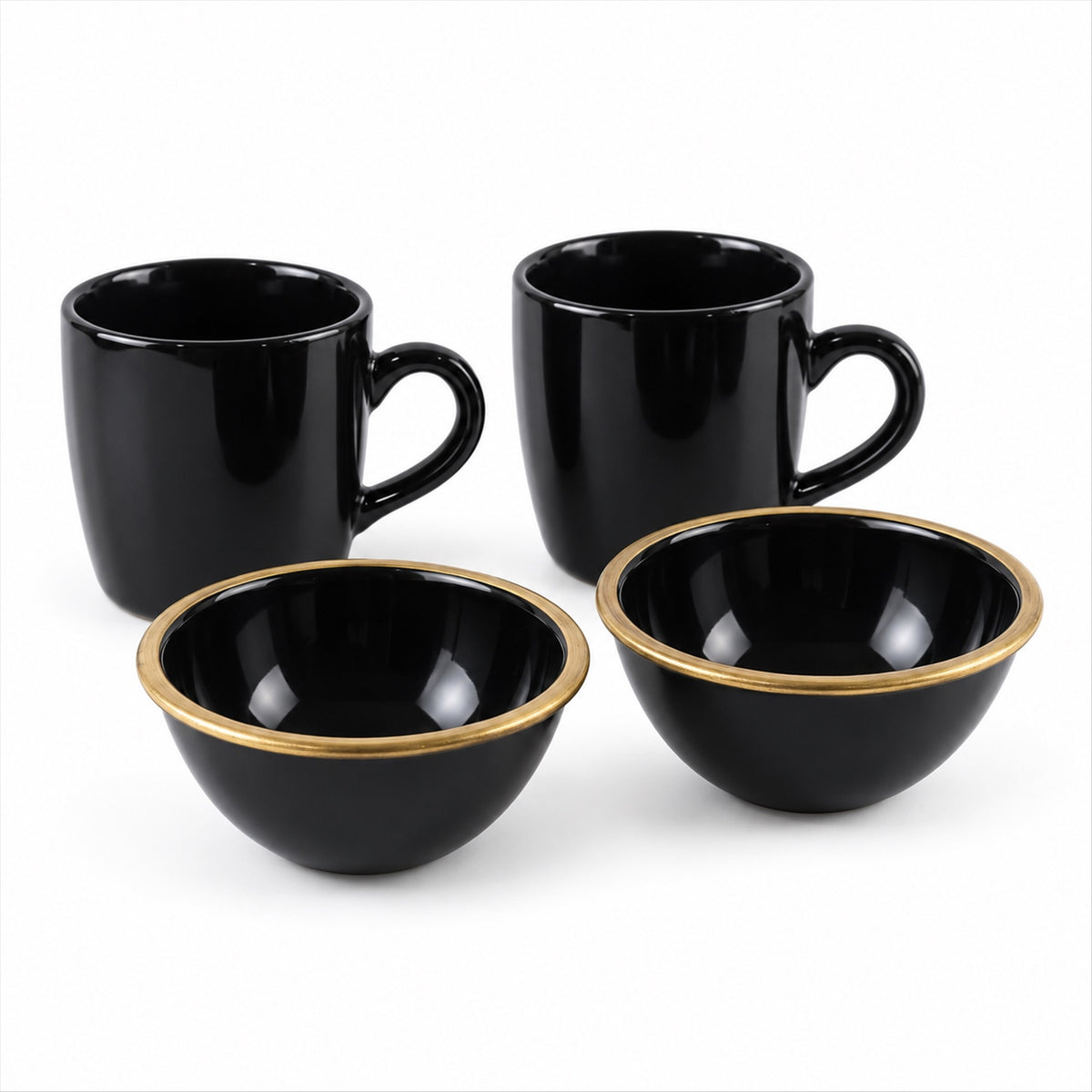 Two glossy black ceramic mugs and two matching bowls with gold rims are arranged on a white background.