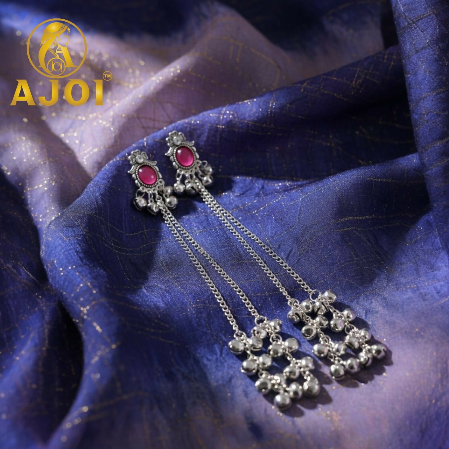 Side view of Kashmiri silver-tone earrings featuring ruby-hued stone and delicate chain drops