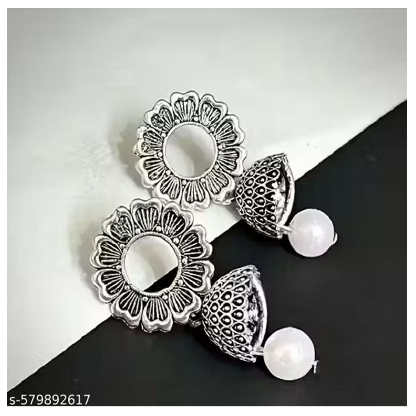 Multiple pairs of small oxidised jhumki earrings arranged together