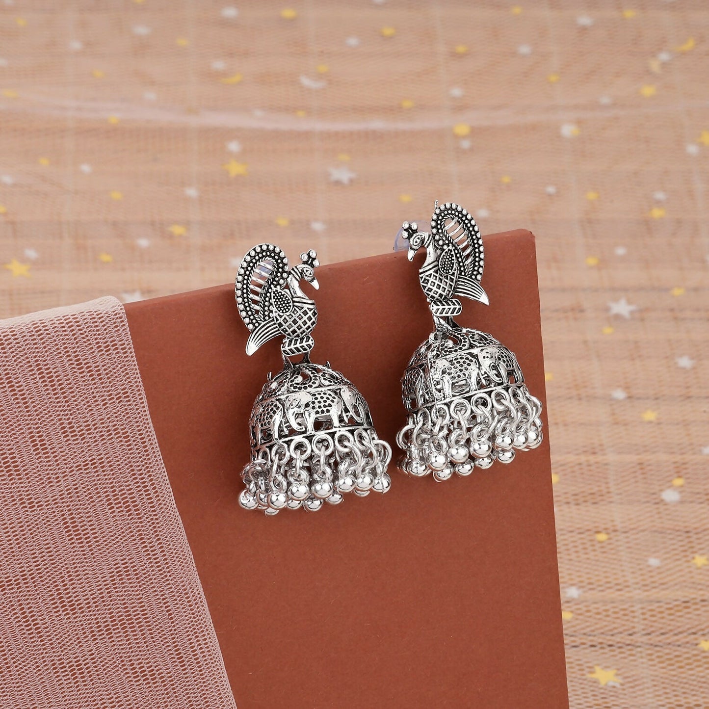 Silver Peacock Jhumka earrings with detailed blue oxidised peacock motif