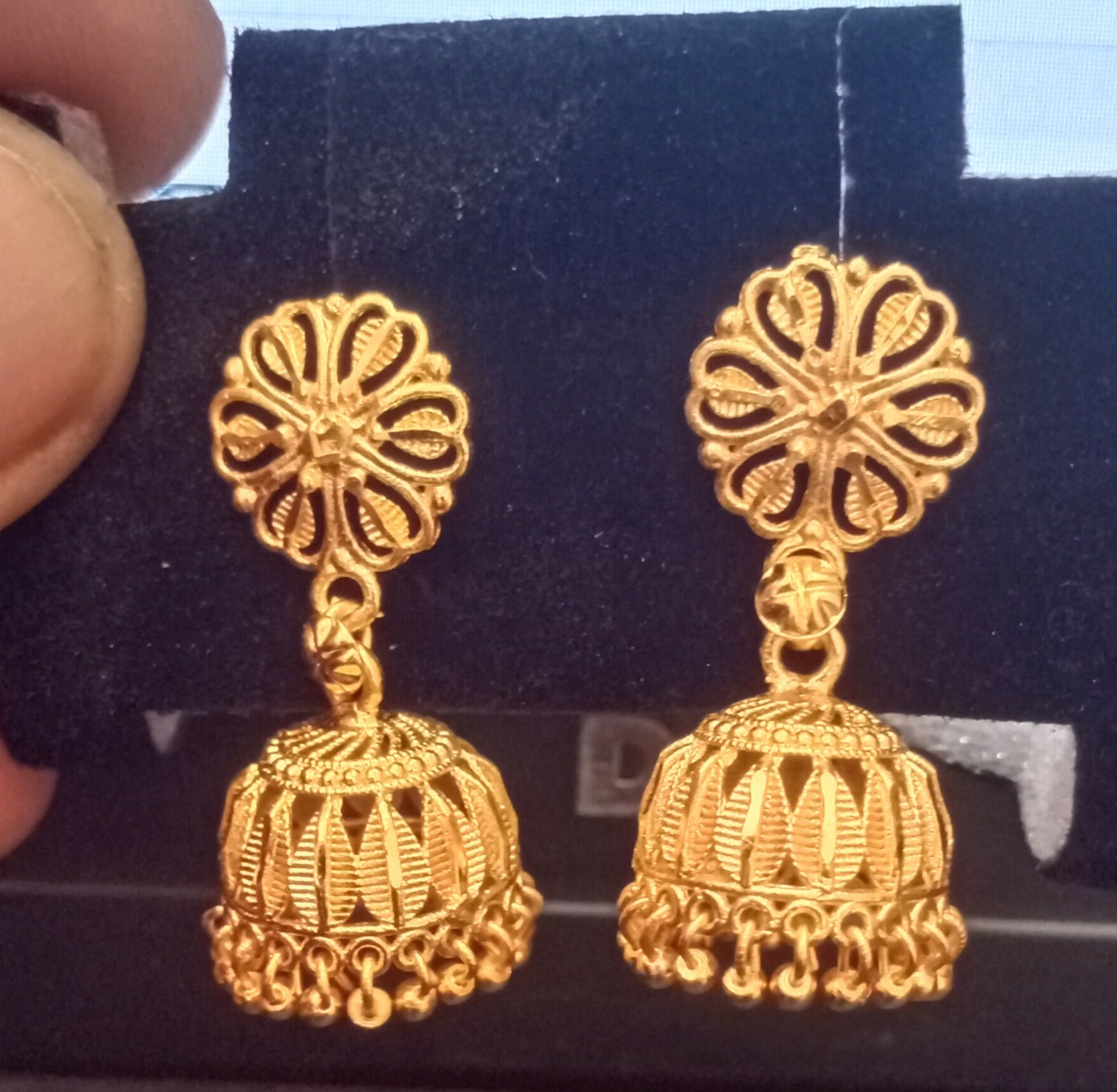 Gold plated traditional jhumka earrings styled with ethnic outfit