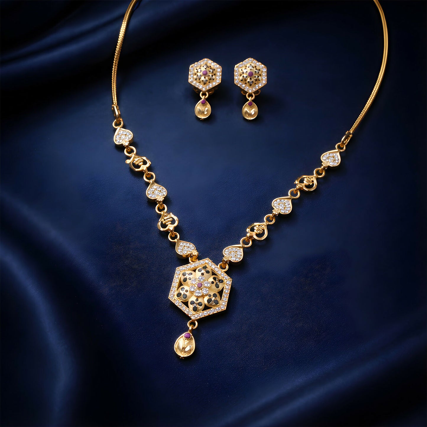 Close-up of designer gold-tone necklace set with sparkling stones