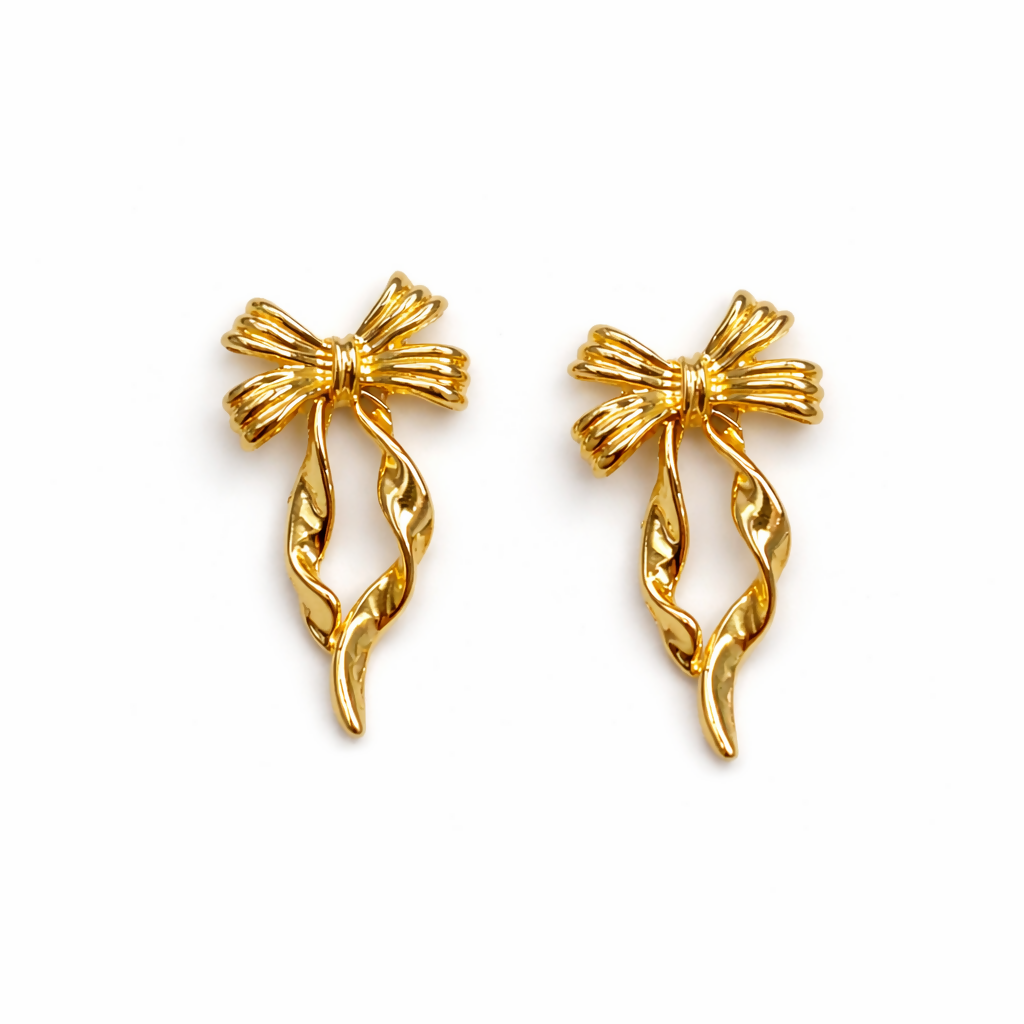 Stylish gold bow drop earrings close-up