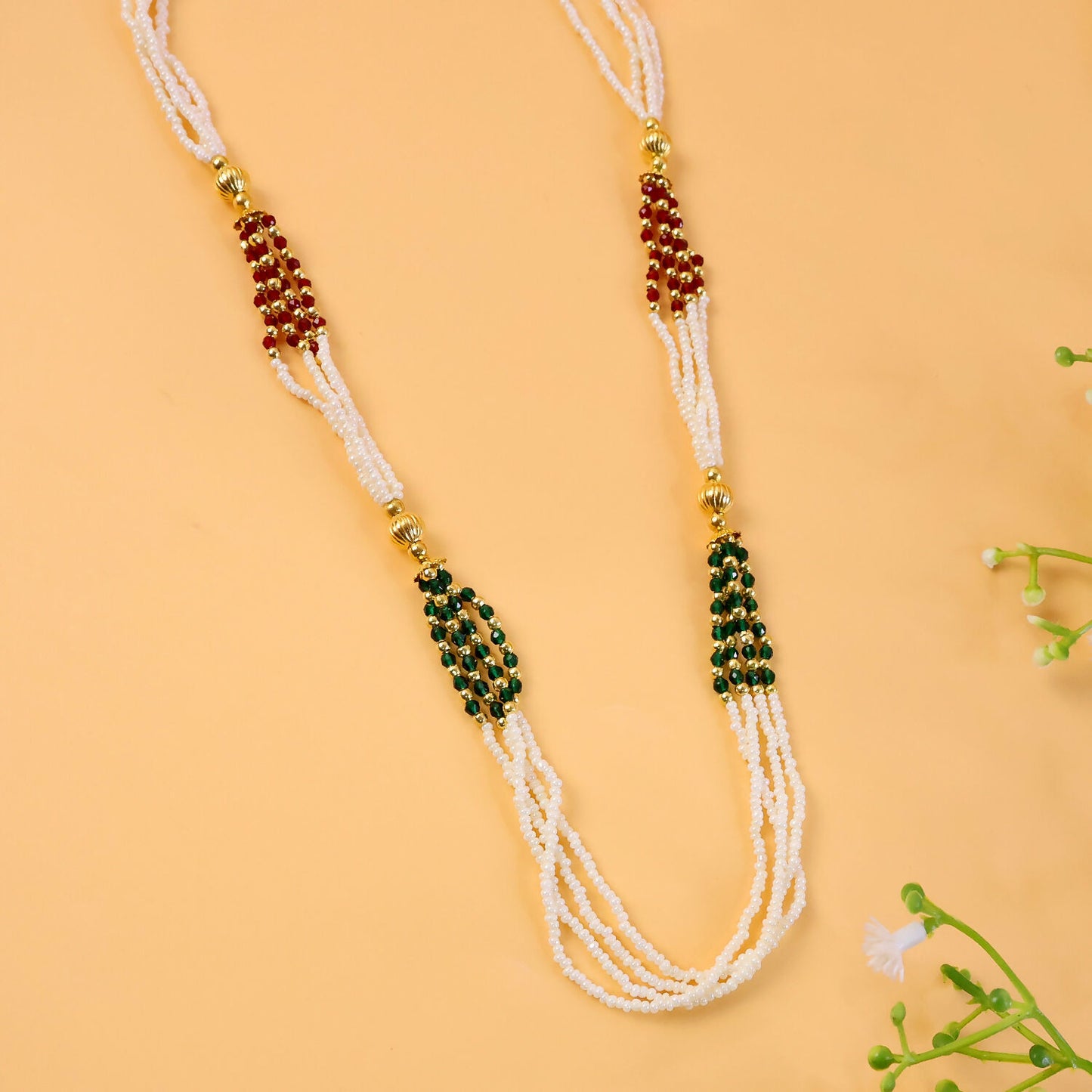 Side view of multi-strand white beaded mala necklace with colorful highlights