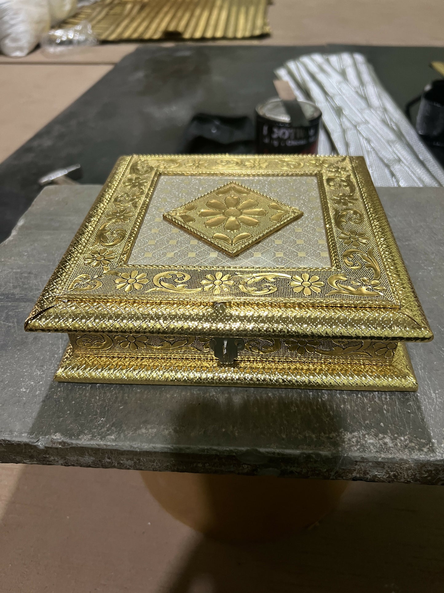 Close-up detail of golden embossed floral metal jewelry box