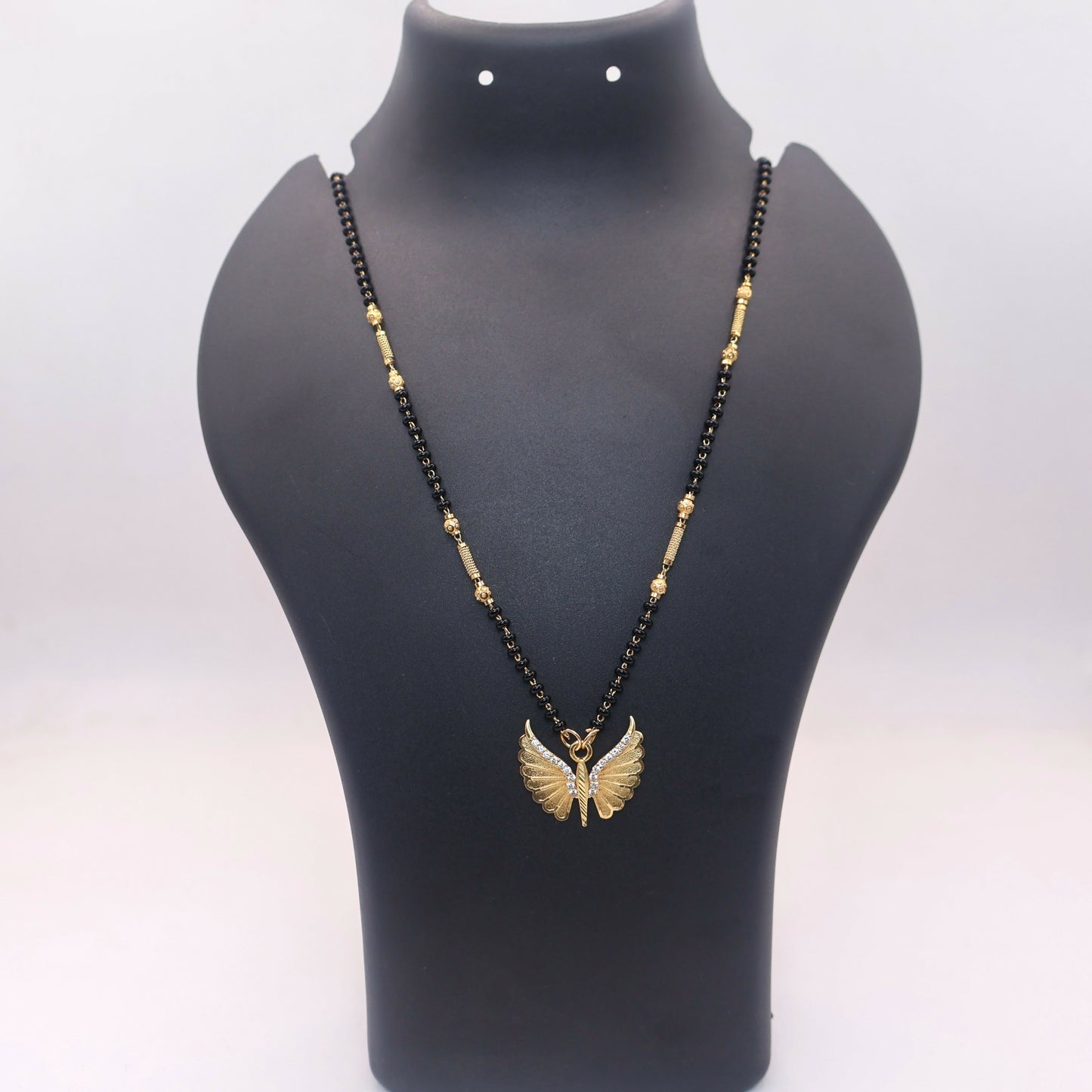 Butterfly wing pendant mangal sutra with black beads, showcasing texture and design