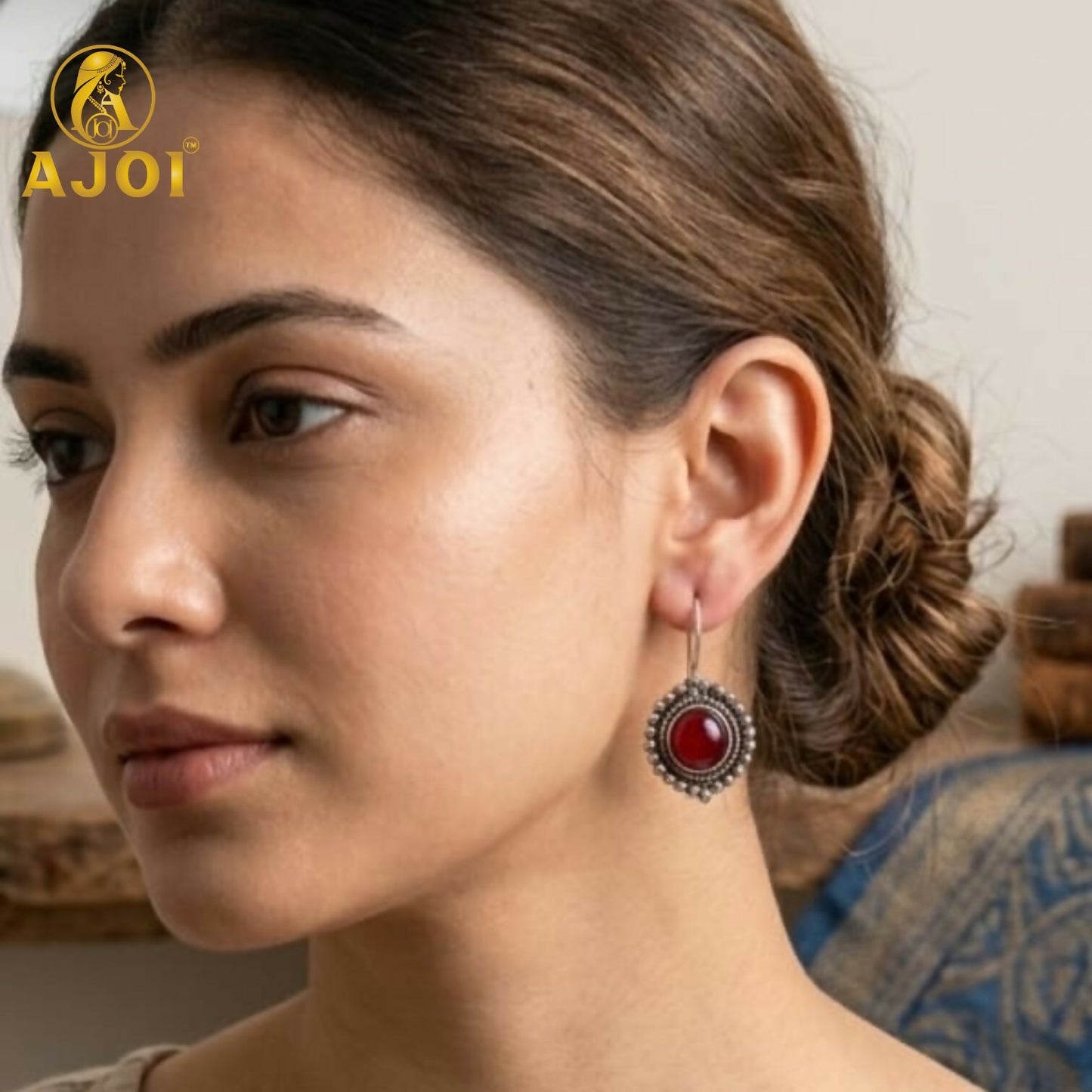 Close-up of oxidized silver earrings with colorful round stones