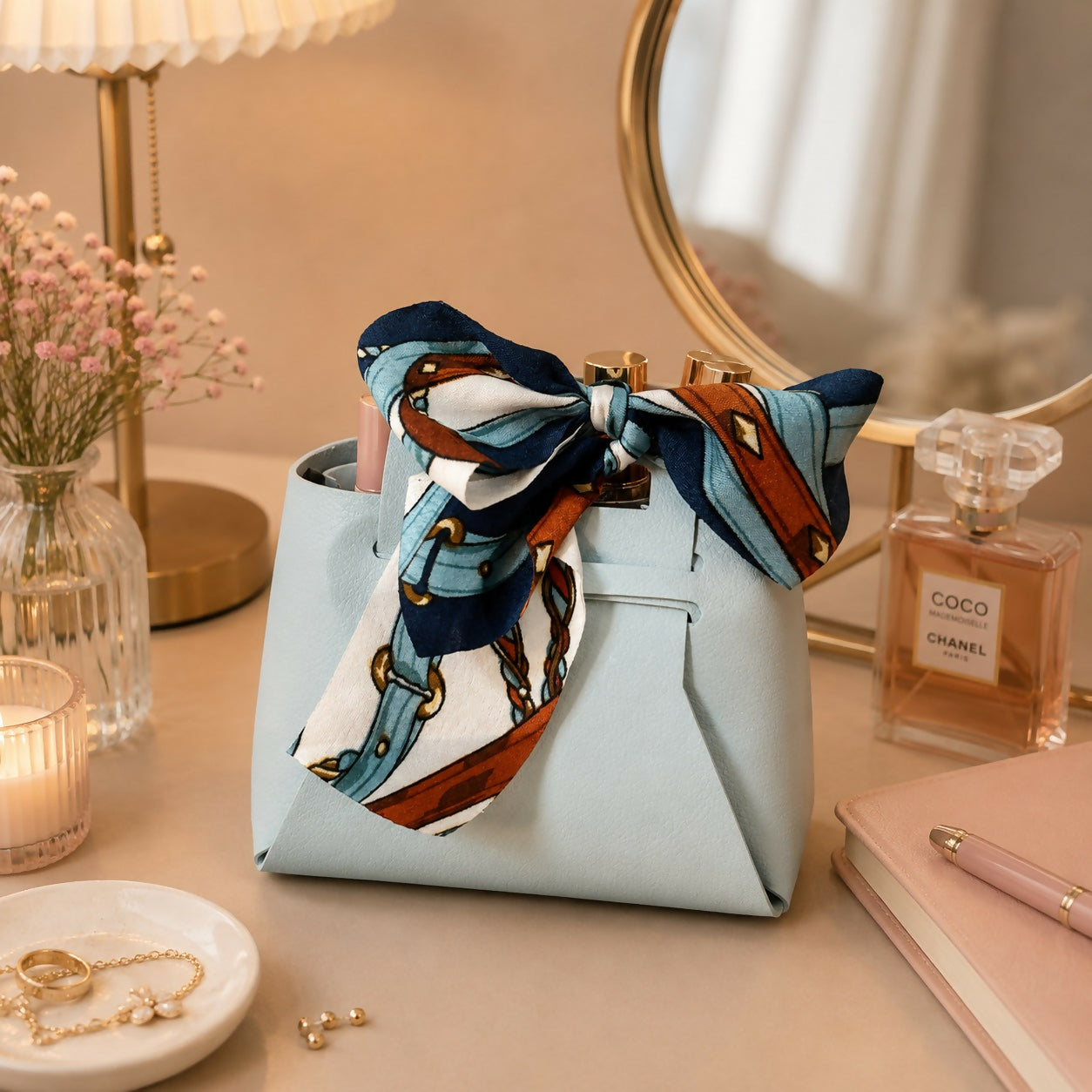 Mini sky blue handbag organizer with printed bow scarf on white background
