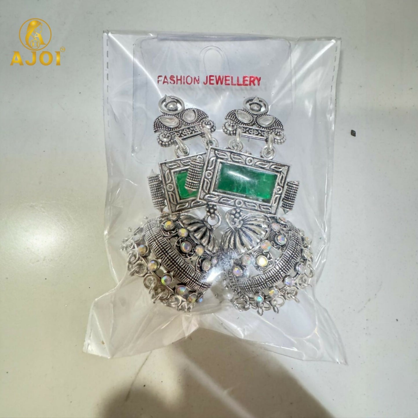 Imperial Heritage Oxidized Silver Jhumka Earrings with Deep Green Stone, Hand-Engraved Motifs, Crystal Accents & Pearl Drop Detailing.