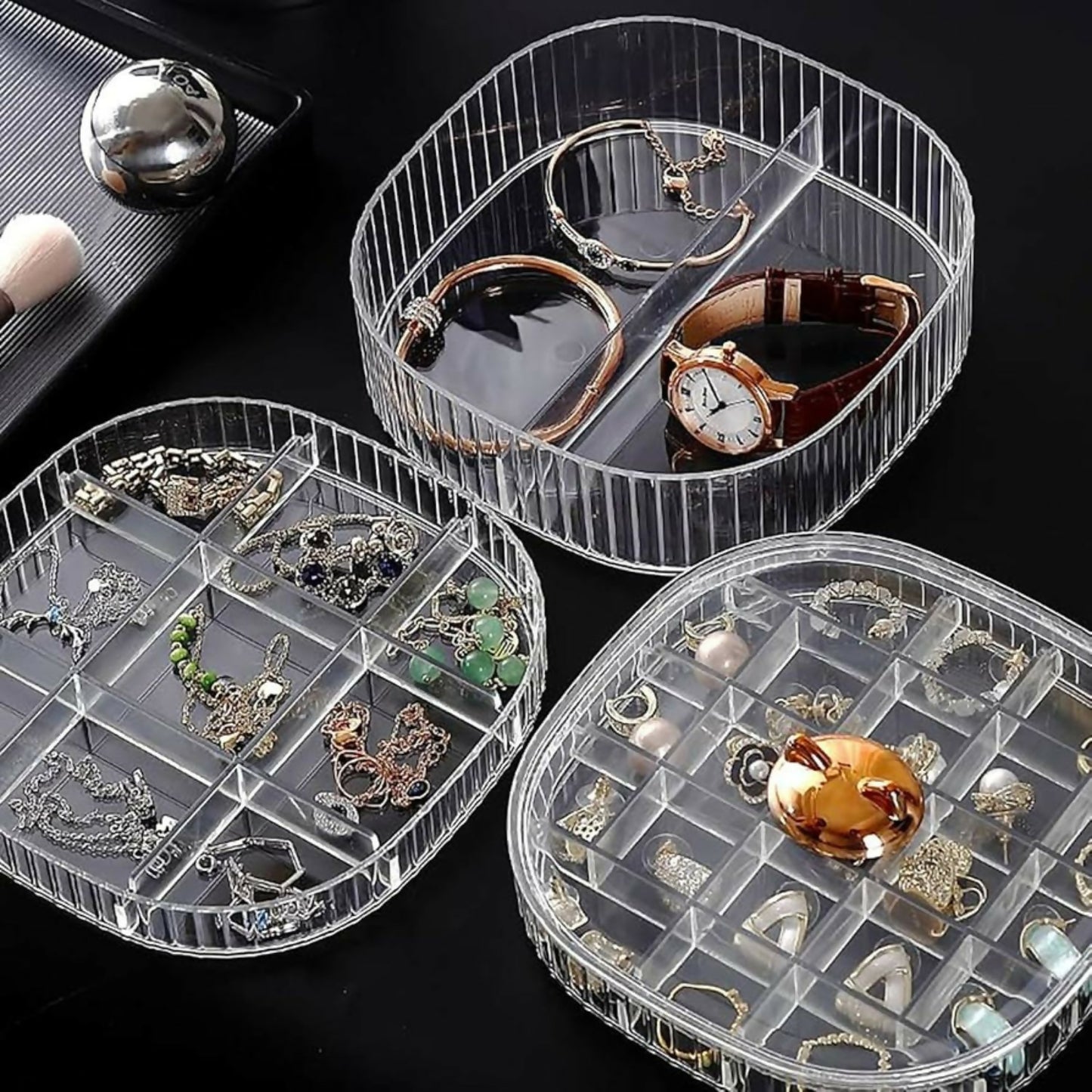 Hand rotating the transparent jewelry storage case to access different layers