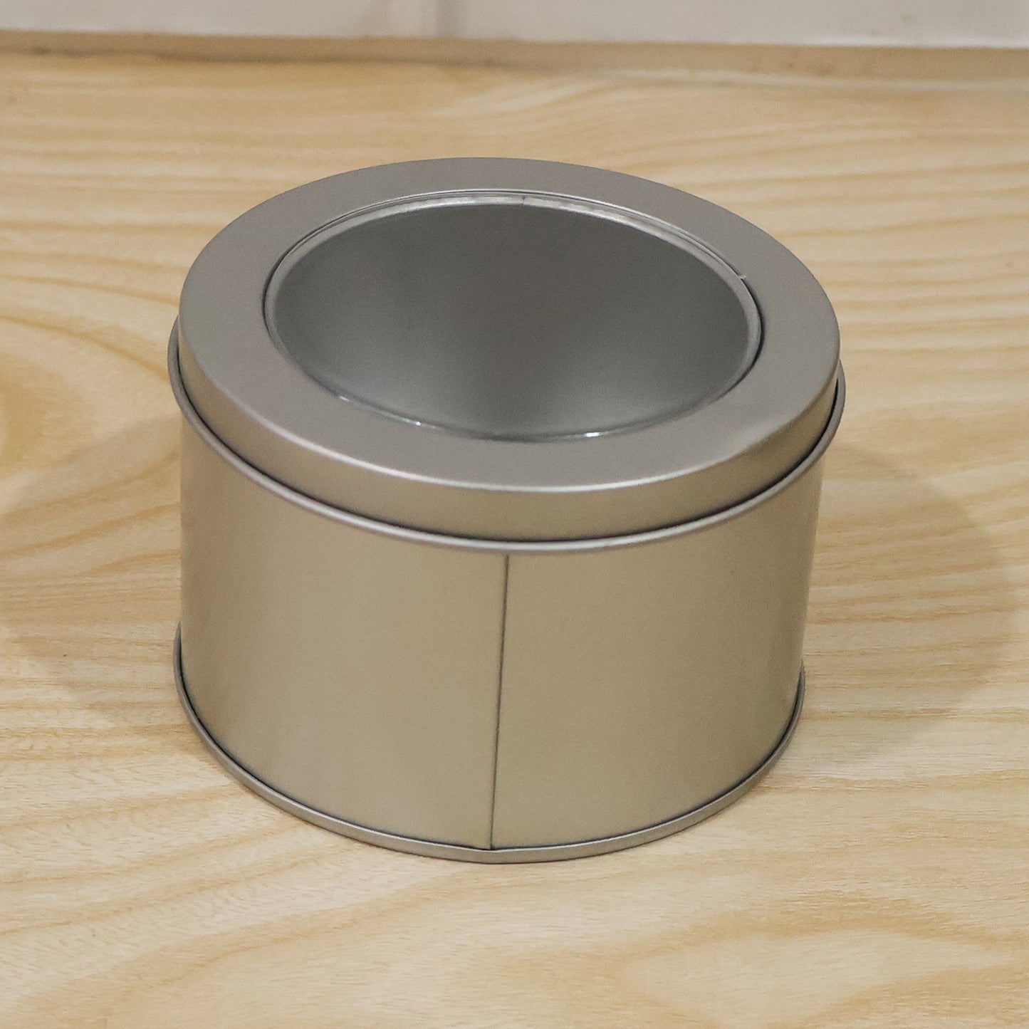 Premium finish round metal storage tin with transparent lid for gifting or organising.