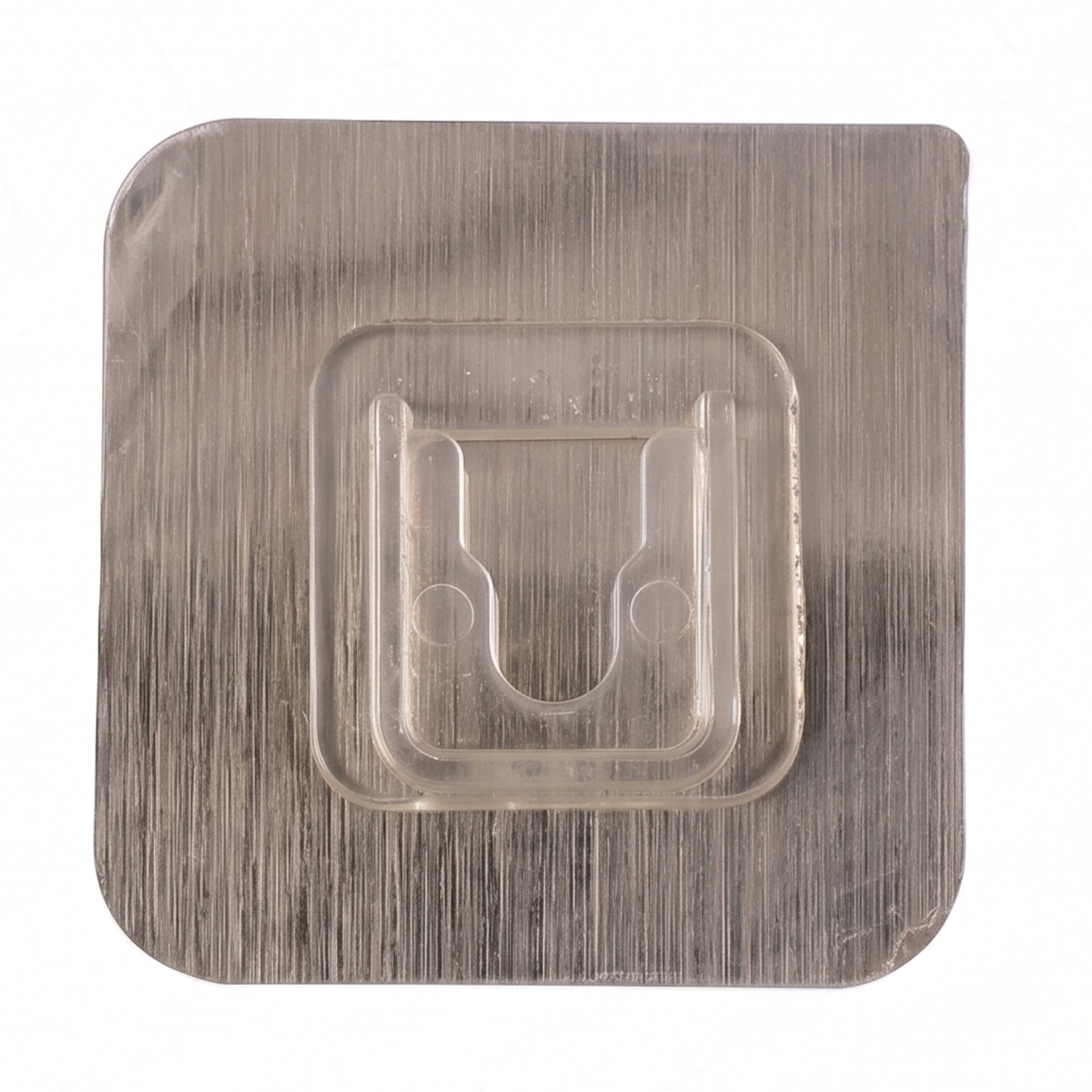 Close-up of sticky transparent wall hook installation