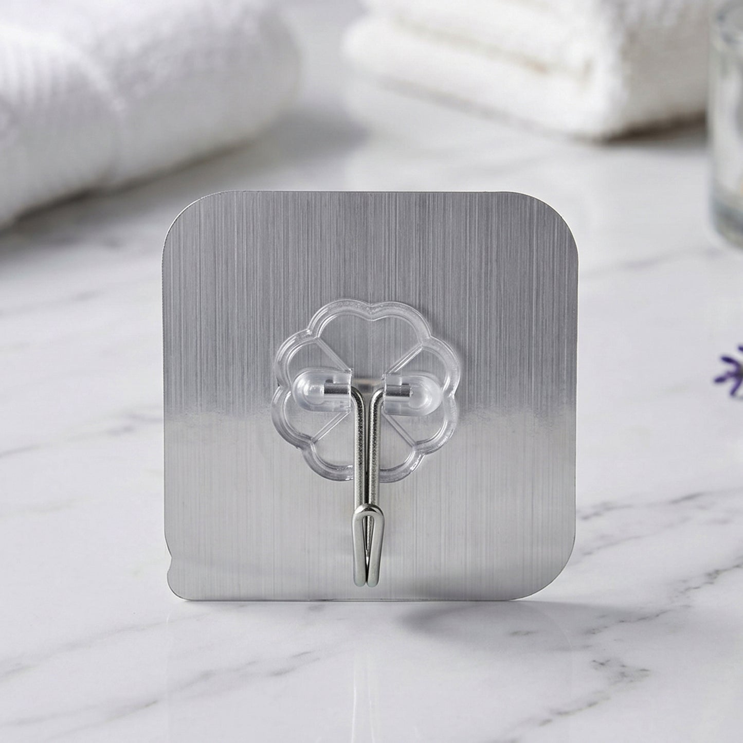 Transparent wall hook showing adhesive backing