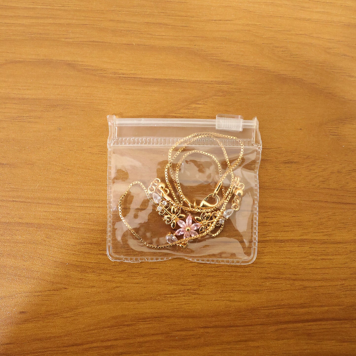 Luxury pink floral pendant necklace with elegant gold finish and crystal drop shown on a model