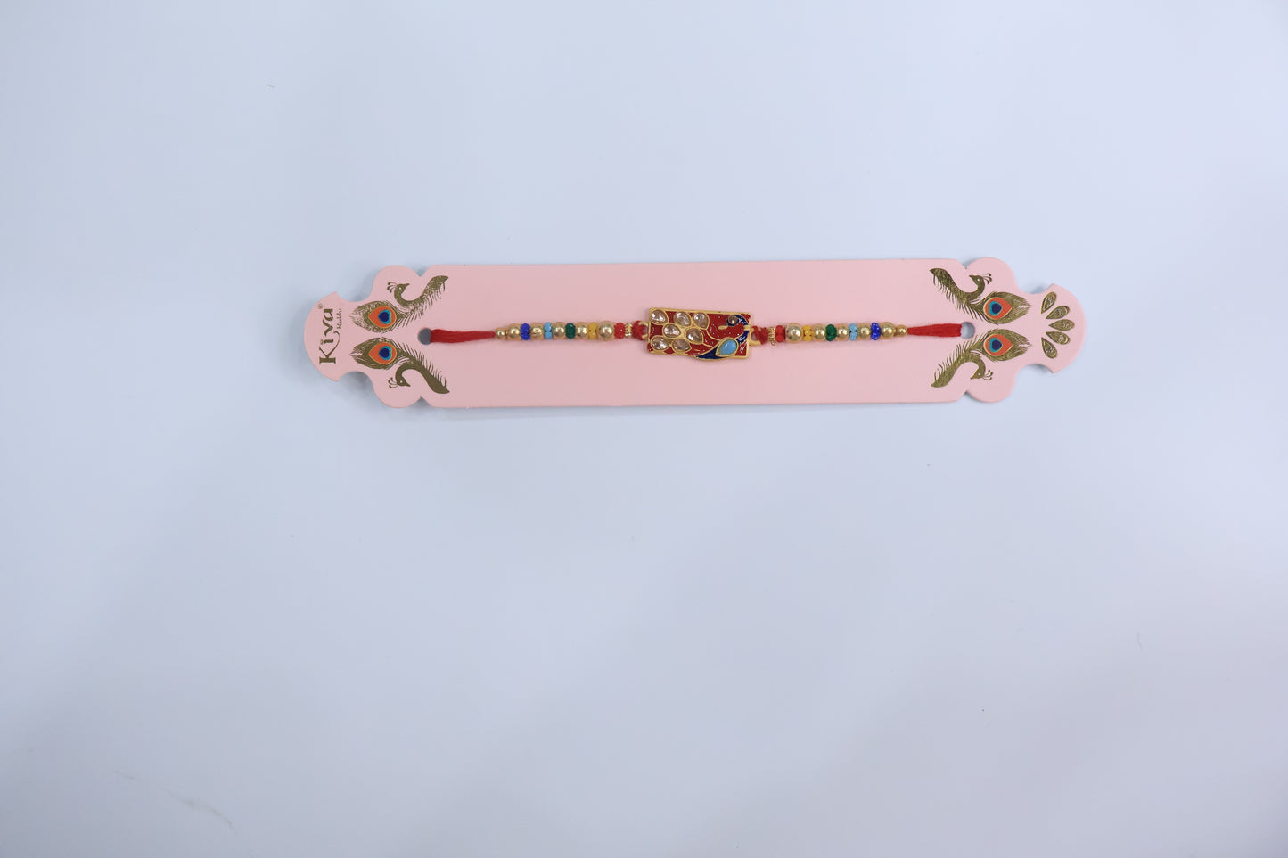 Elegant Peacock Design Kundan Rakhi with Red Enamel Dial and Multicolor Beads – Premium Traditional Rakhi for Raksha Bandhan