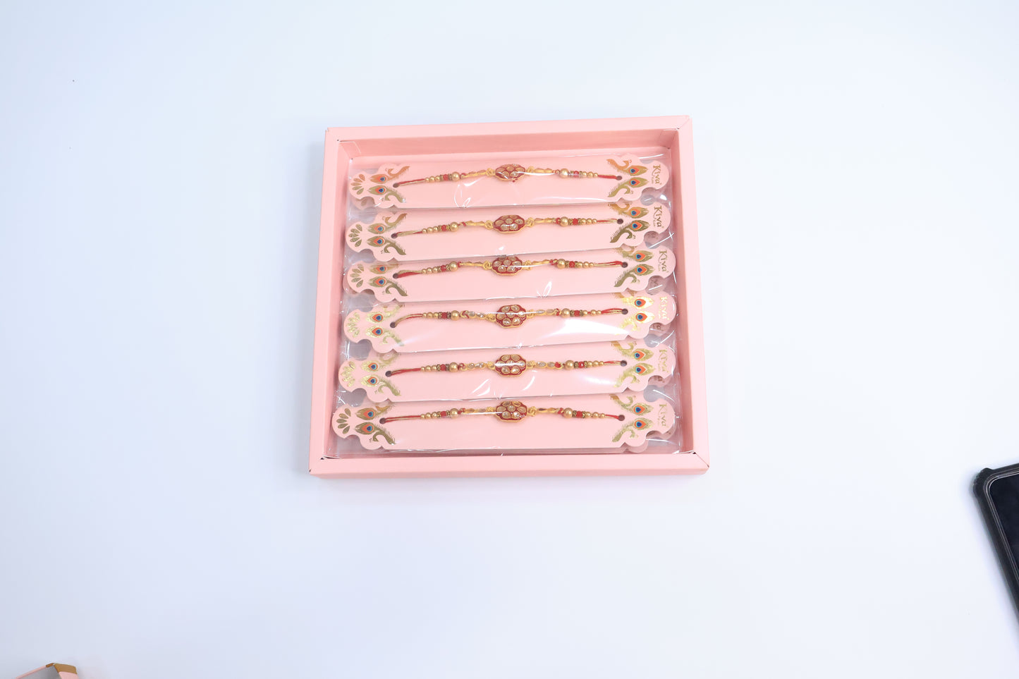 12 Pc Royal Kundan Rakhi Set with Red Enamel Work and Golden Beads – Premium Traditional Gift Box for Raksha Bandhan