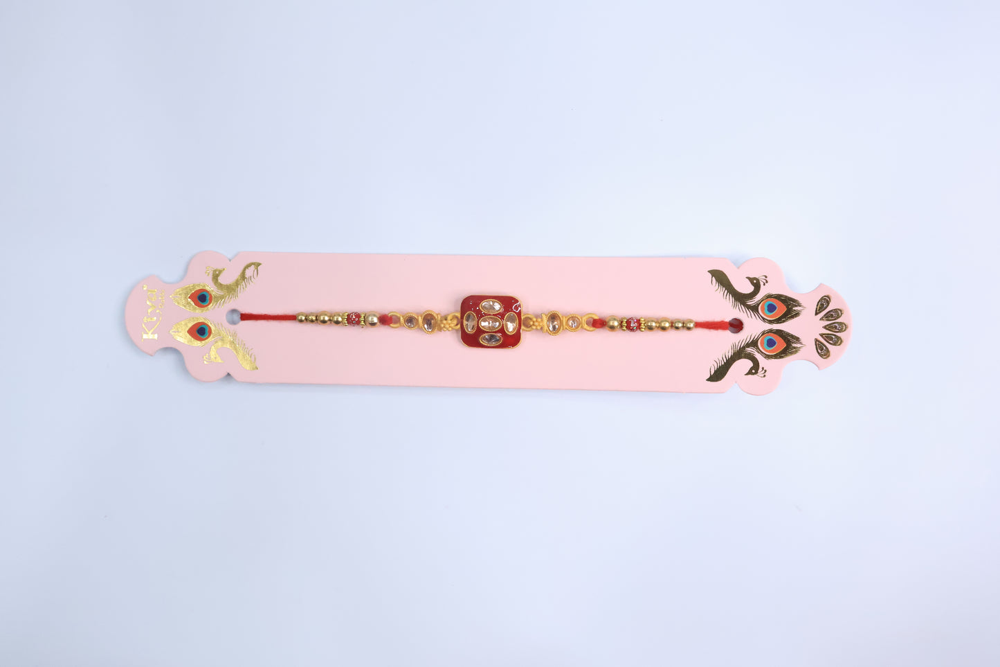 Traditional Square Kundan Rakhi with Red Enamel Dial and Golden Beads – Elegant Designer Rakhi for Raksha Bandhan