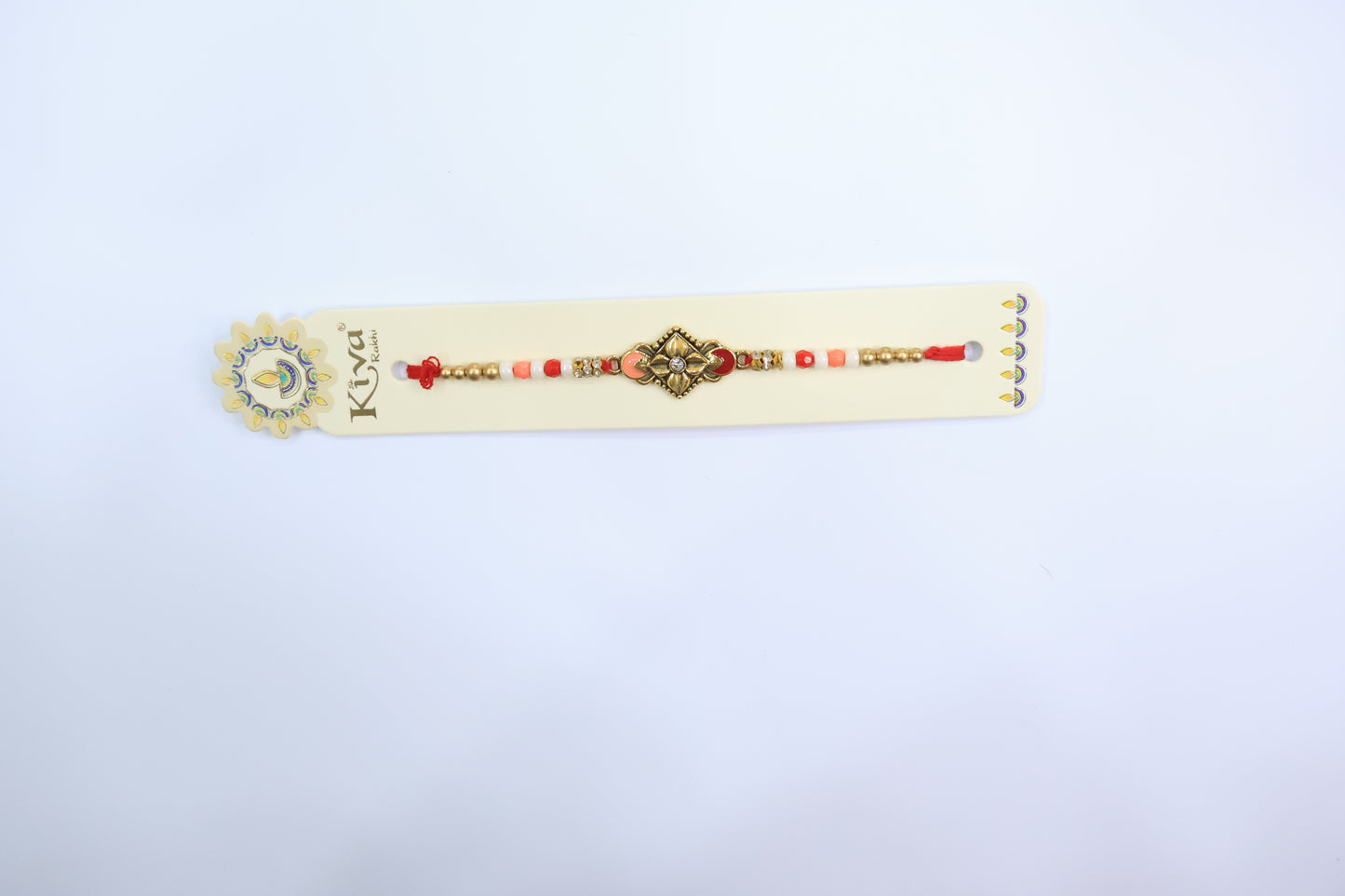 Elegant Antique Gold Rakhi with Diamond-Studded Center and Peach-White Beaded Thread